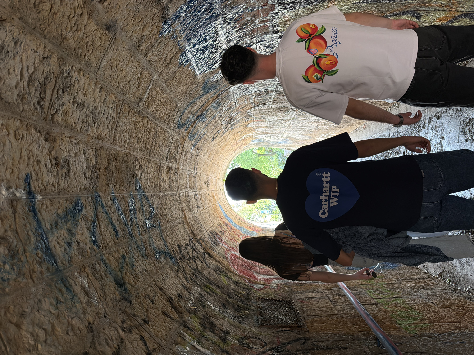 Tourist explores Rijeka coastal paths and tunnels on sunny afternoon