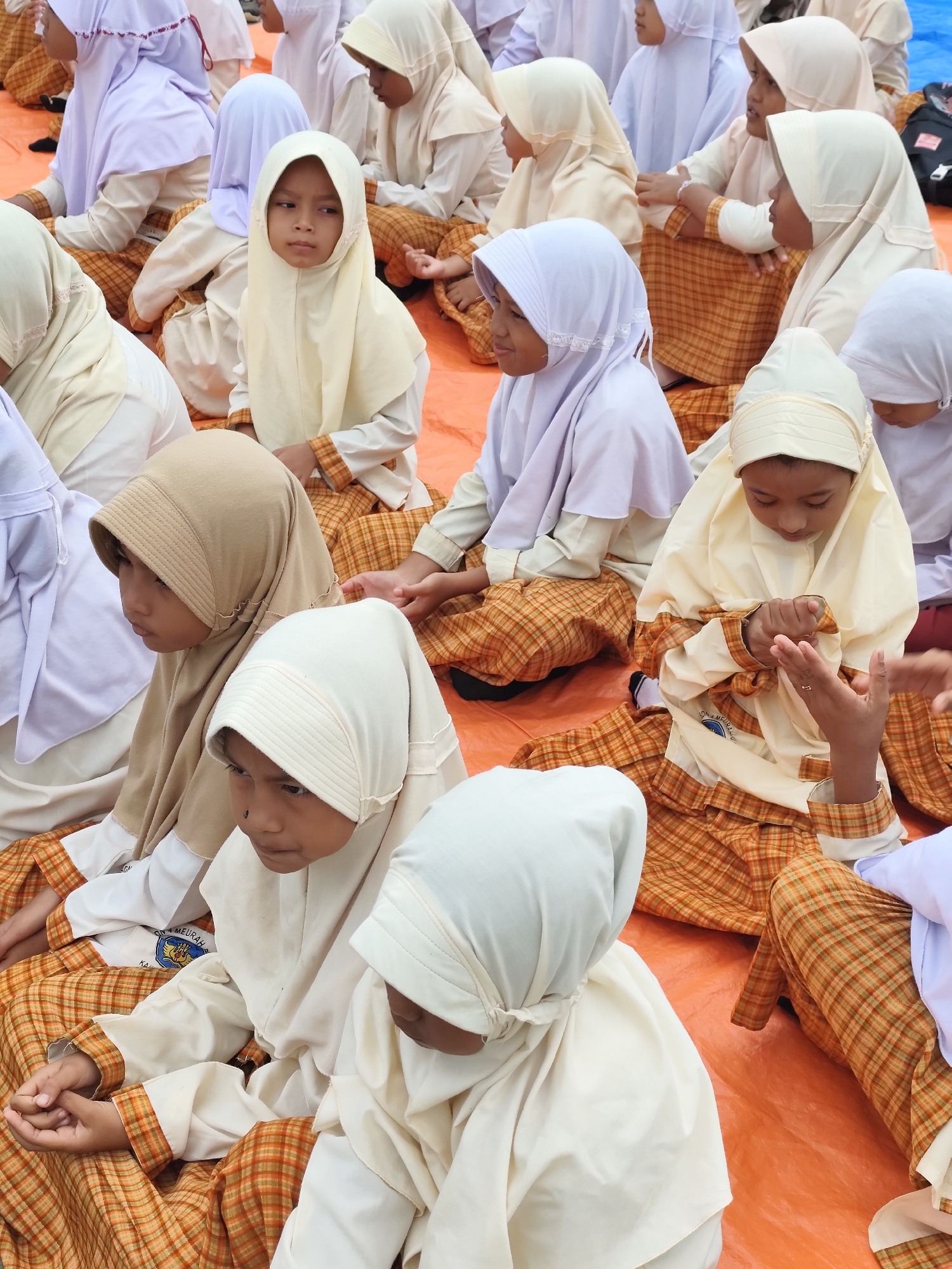 Children in traditional dress gather for an outdoor community event