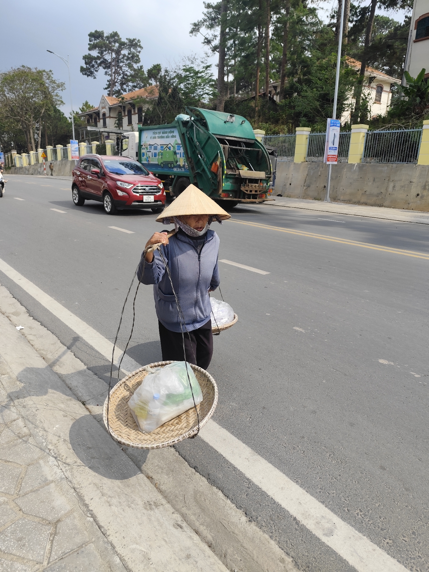 Morning pedestrian spotted amid decaying architecture in Da Lat