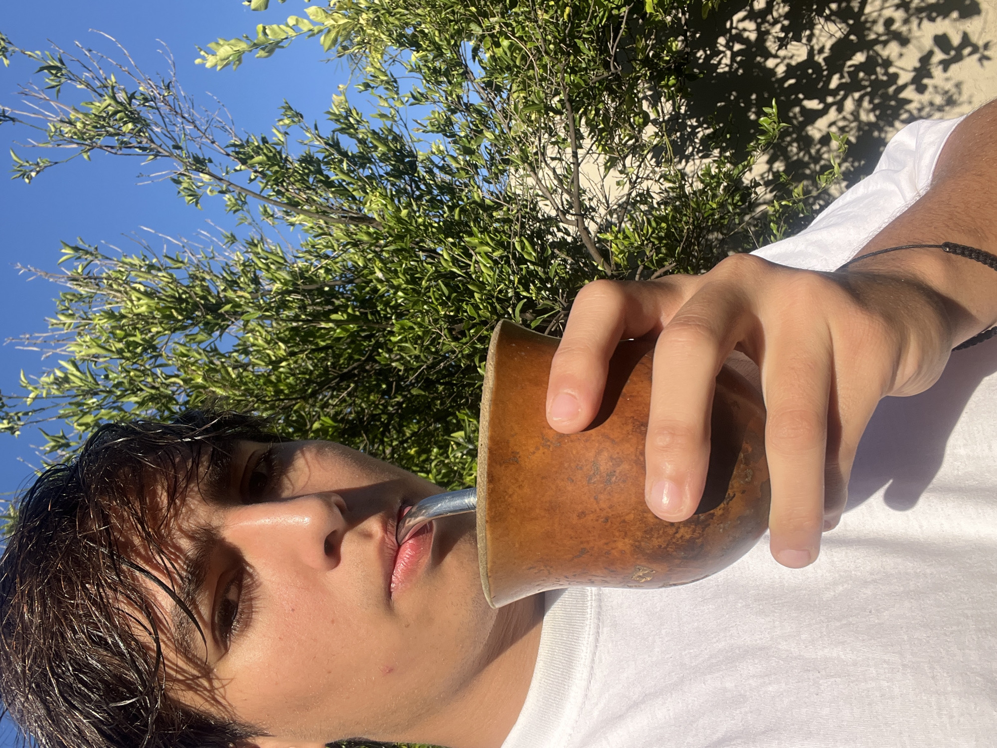 Young man enjoys traditional mate outdoors in Gerli, Argentina