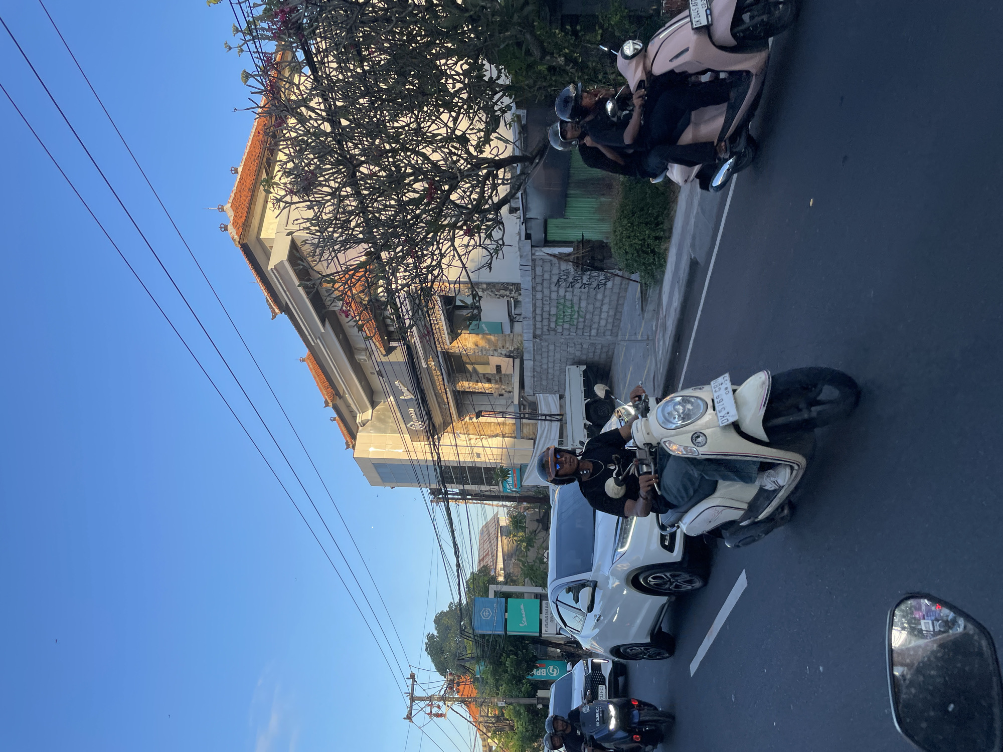 Denpasar street life: traffic, local shops, and city infrastructure
