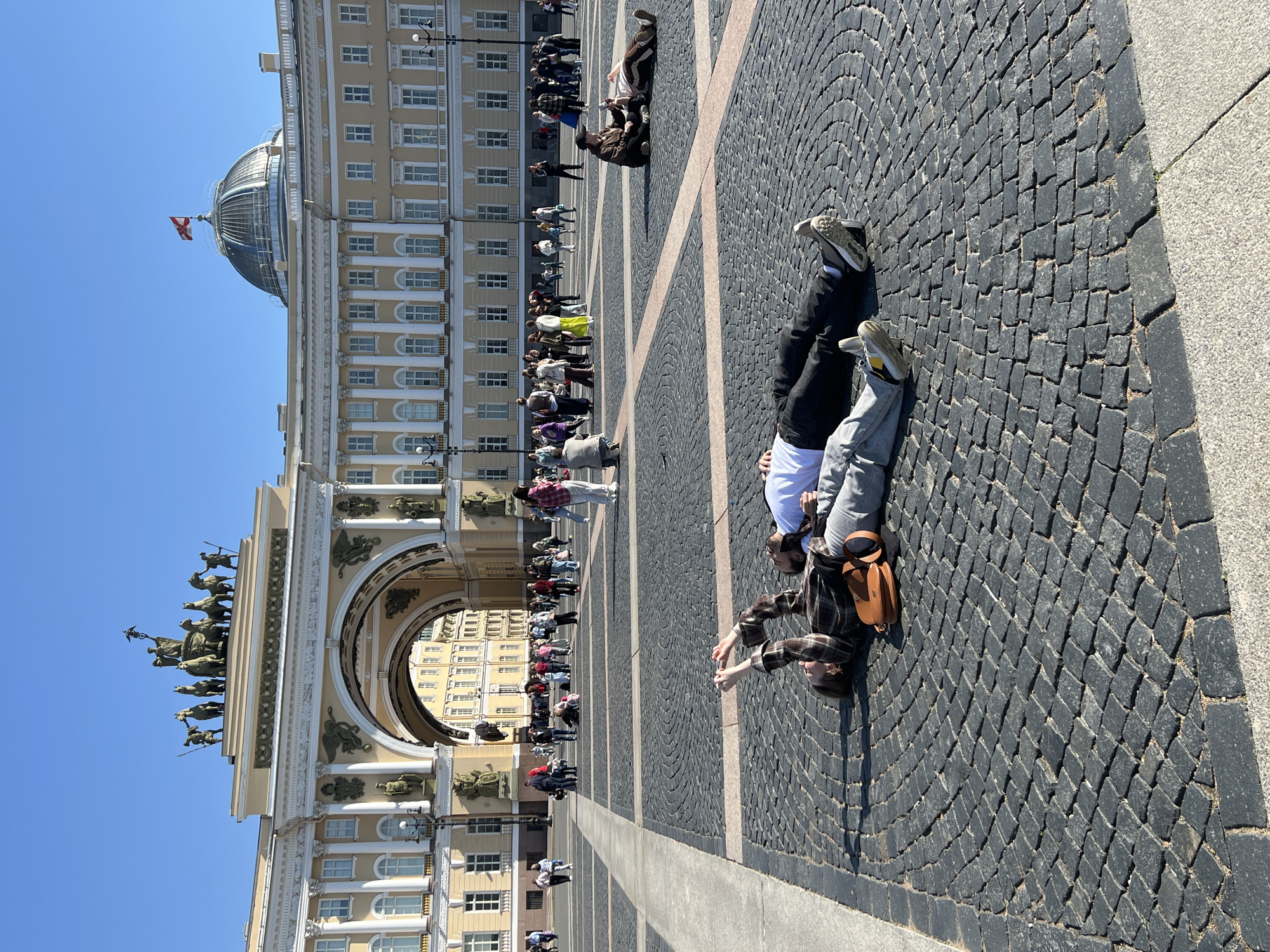 Two people observed on historic Saint Petersburg plaza