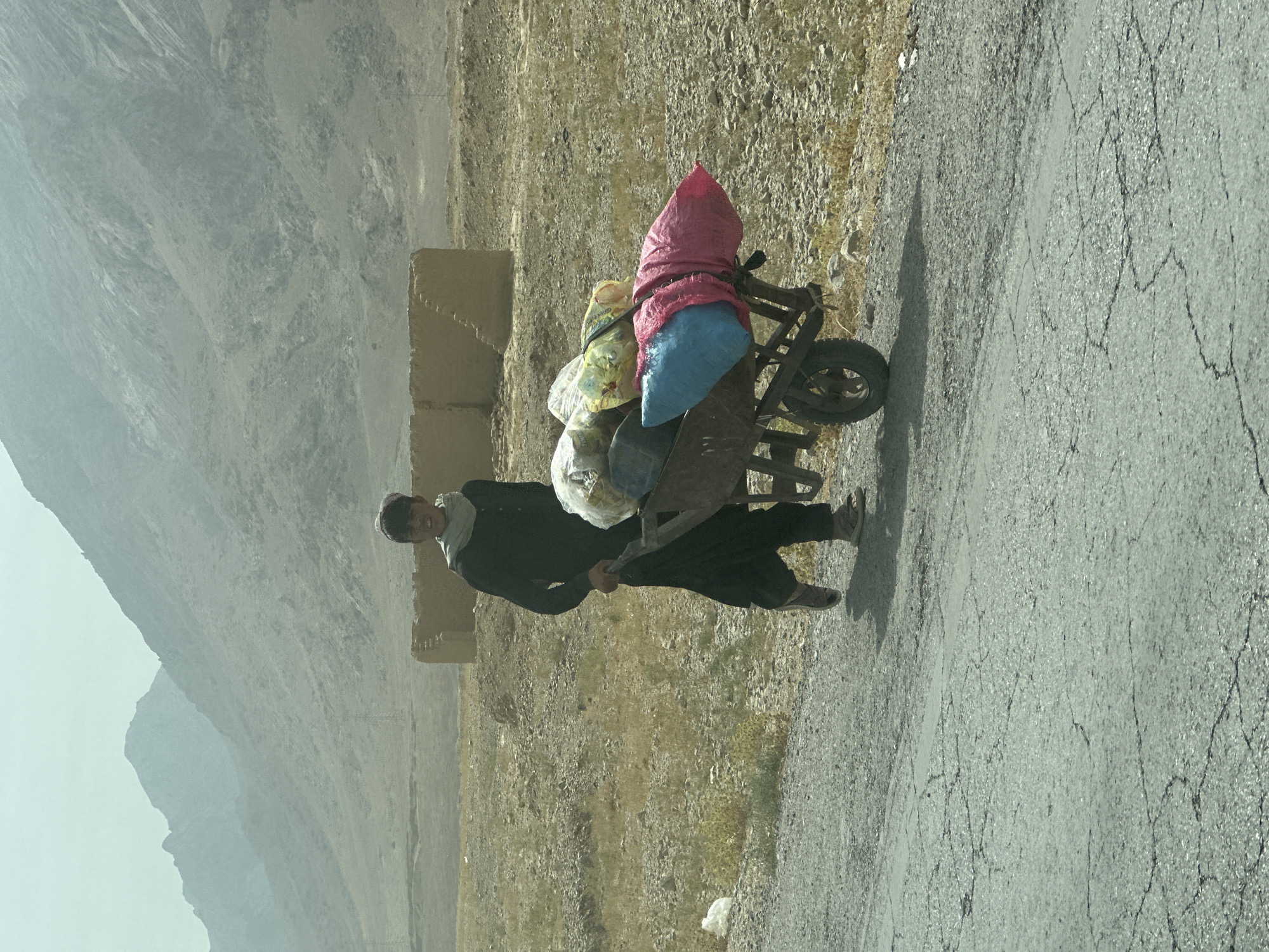 Wheelbarrow loaded with goods on a Khanai Baba road