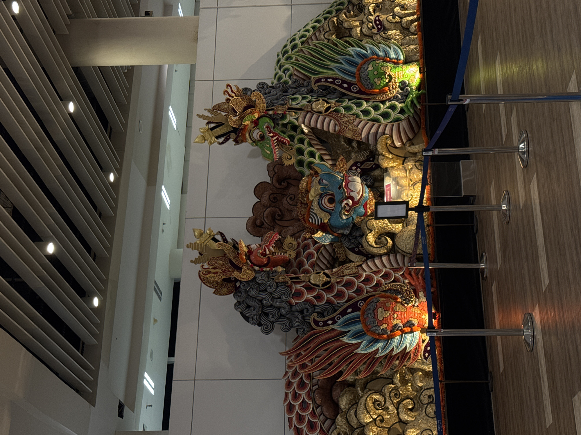 Father and daughter visit decorated public space with dragon artwork