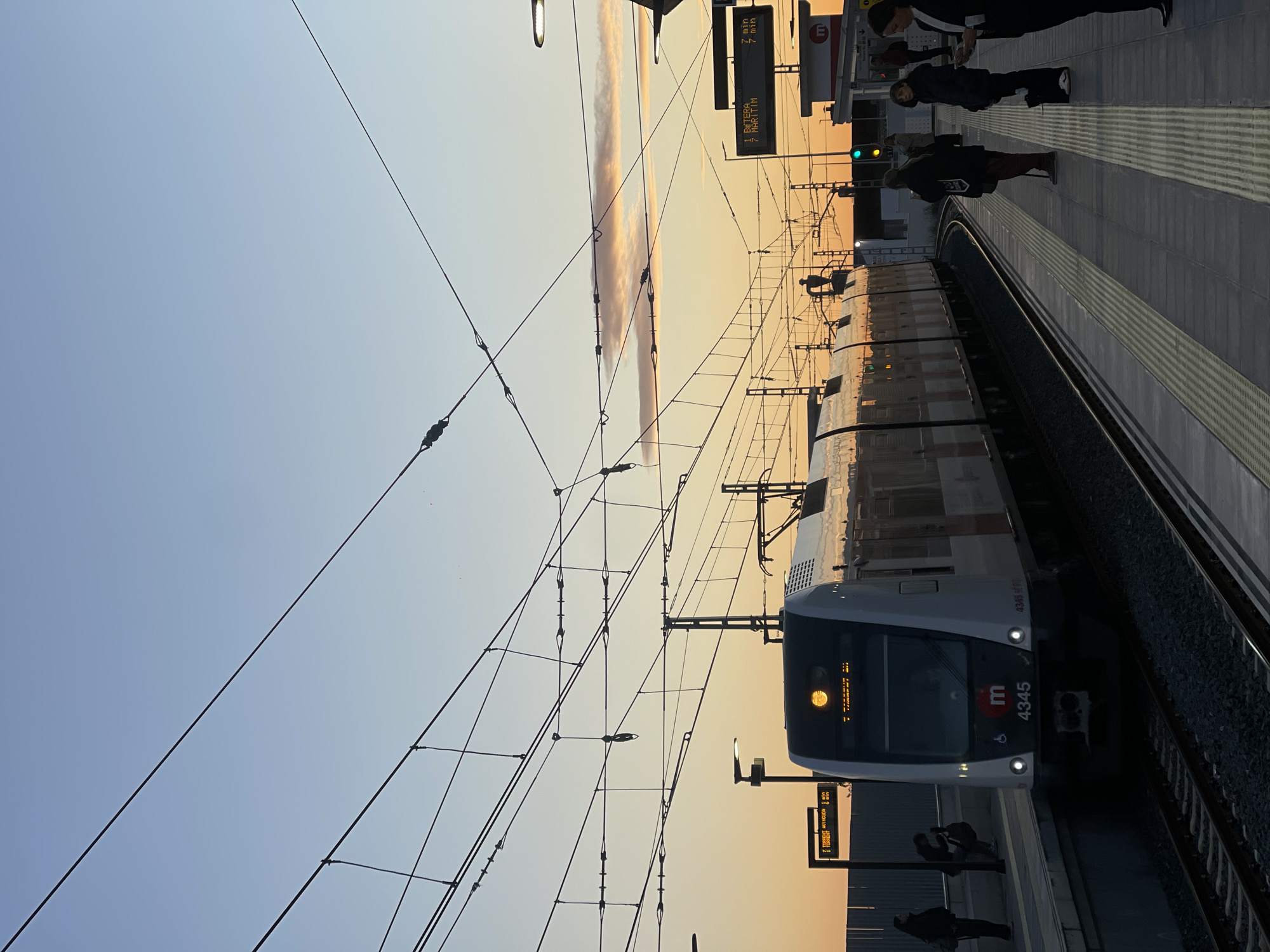 Metro Valencia train arrives at Paiporta station during dawn