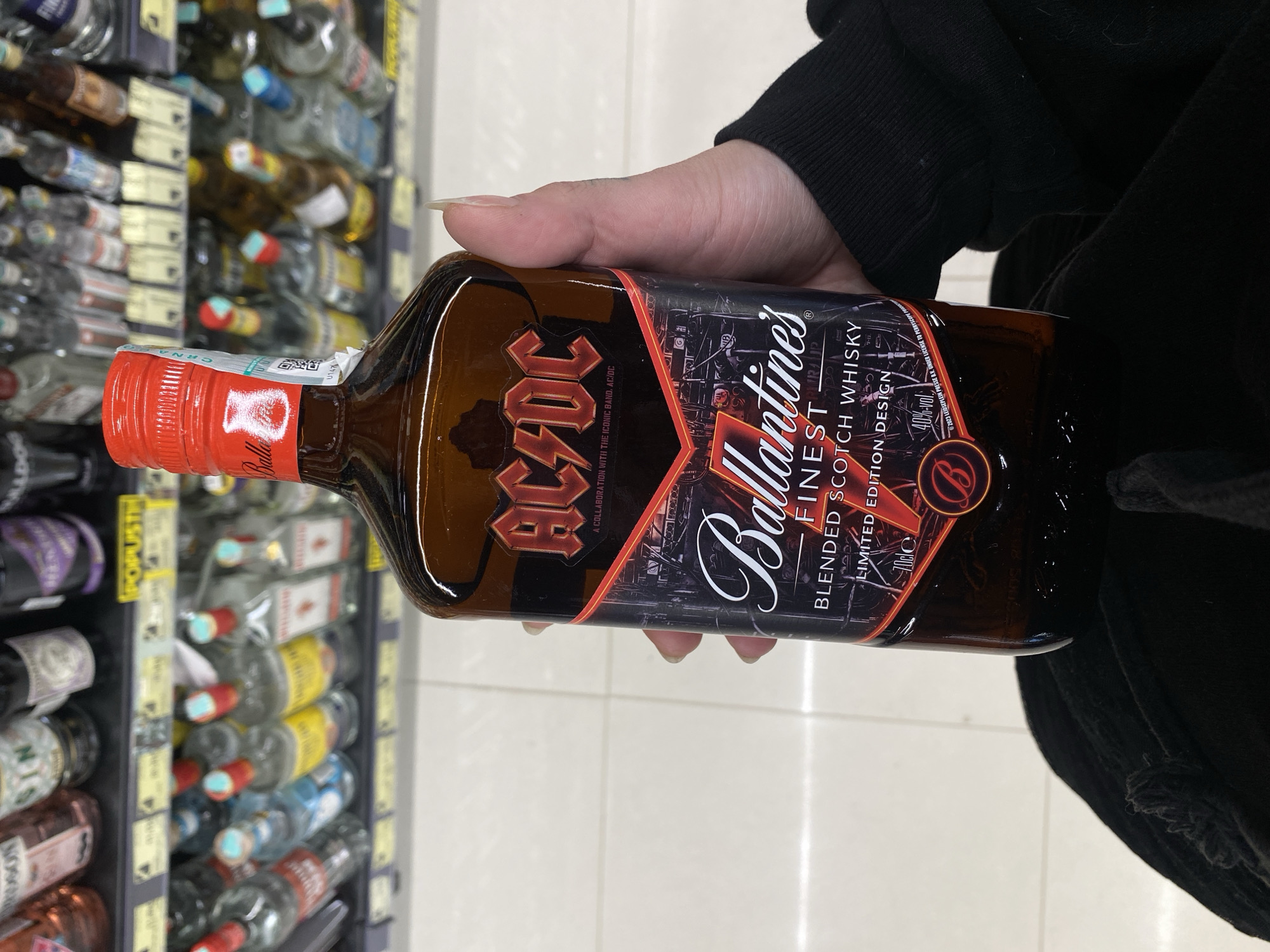 Person takes selfie with whisky bottle in Montenegro store