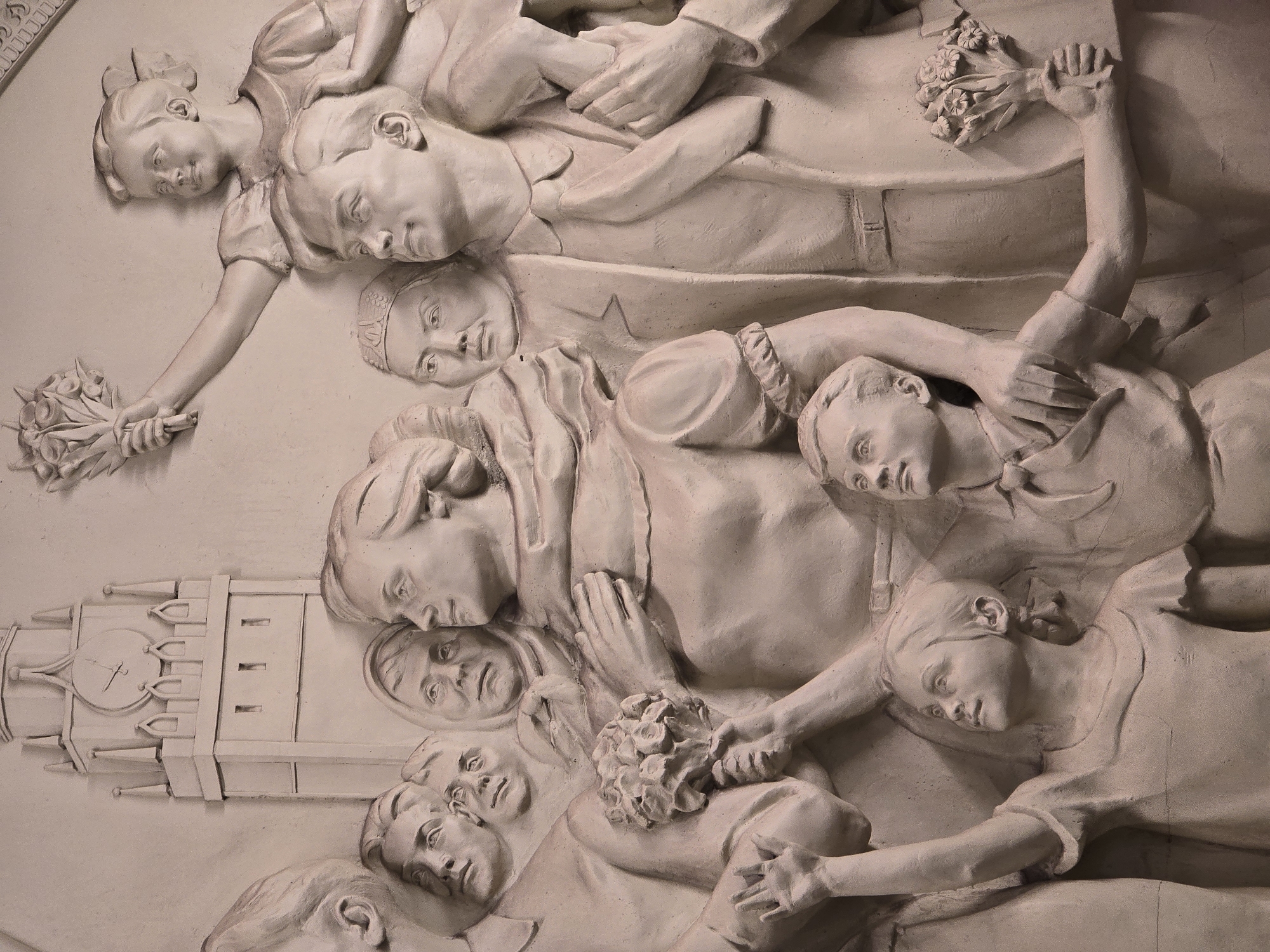 Bas-relief sculpture with adult, children figures observed in Moscow