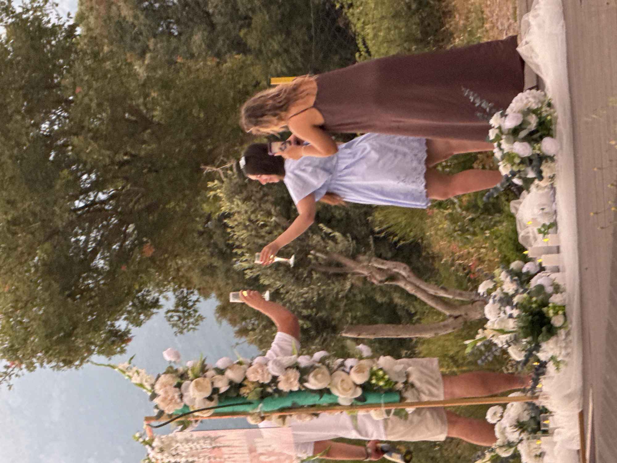 Sunset proposal at a flower arch on the Montenegrin coast