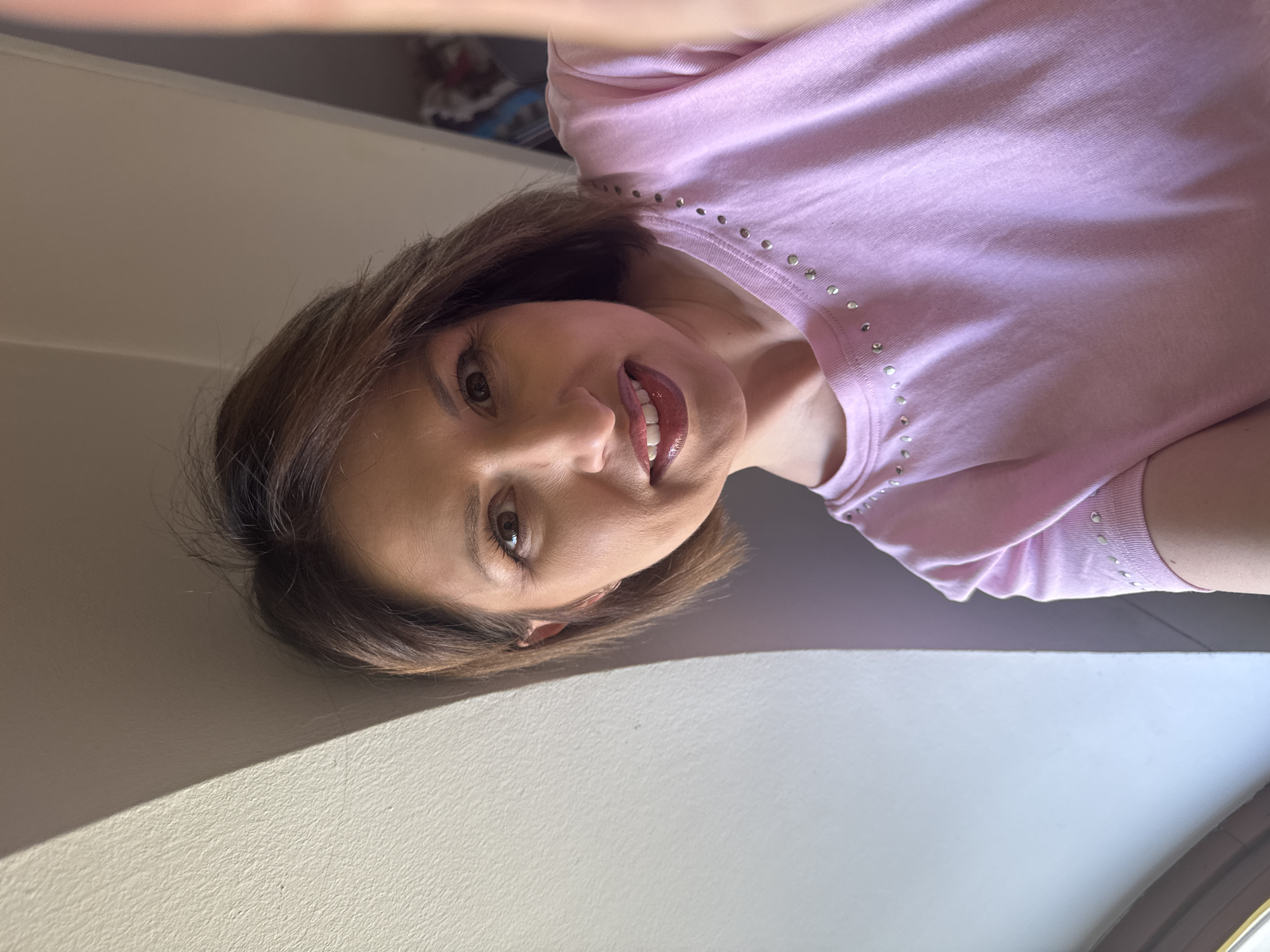 Person takes selfie in pink studded shirt in Sofia