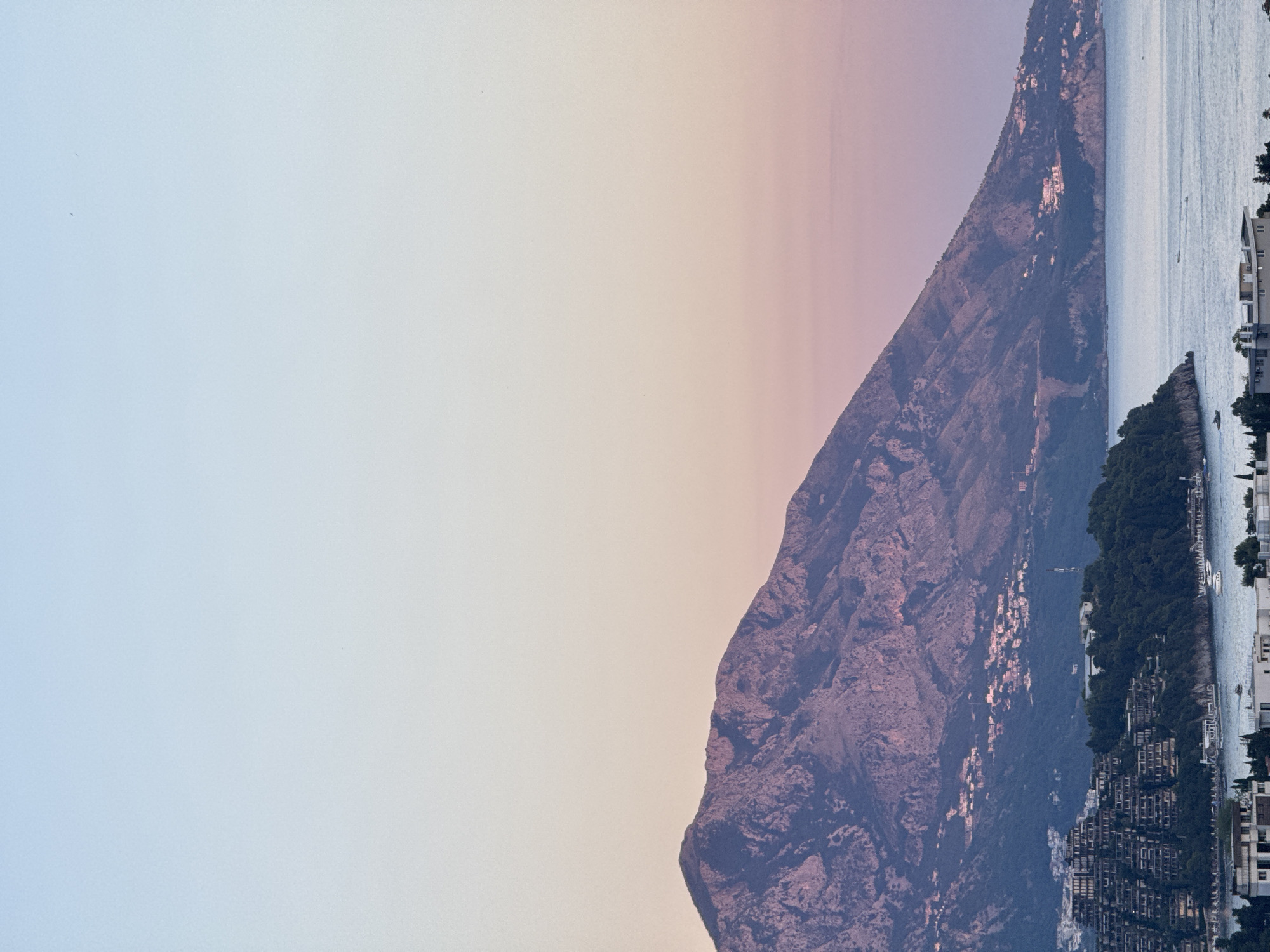 Budva at dusk: coastline, construction, and evening light