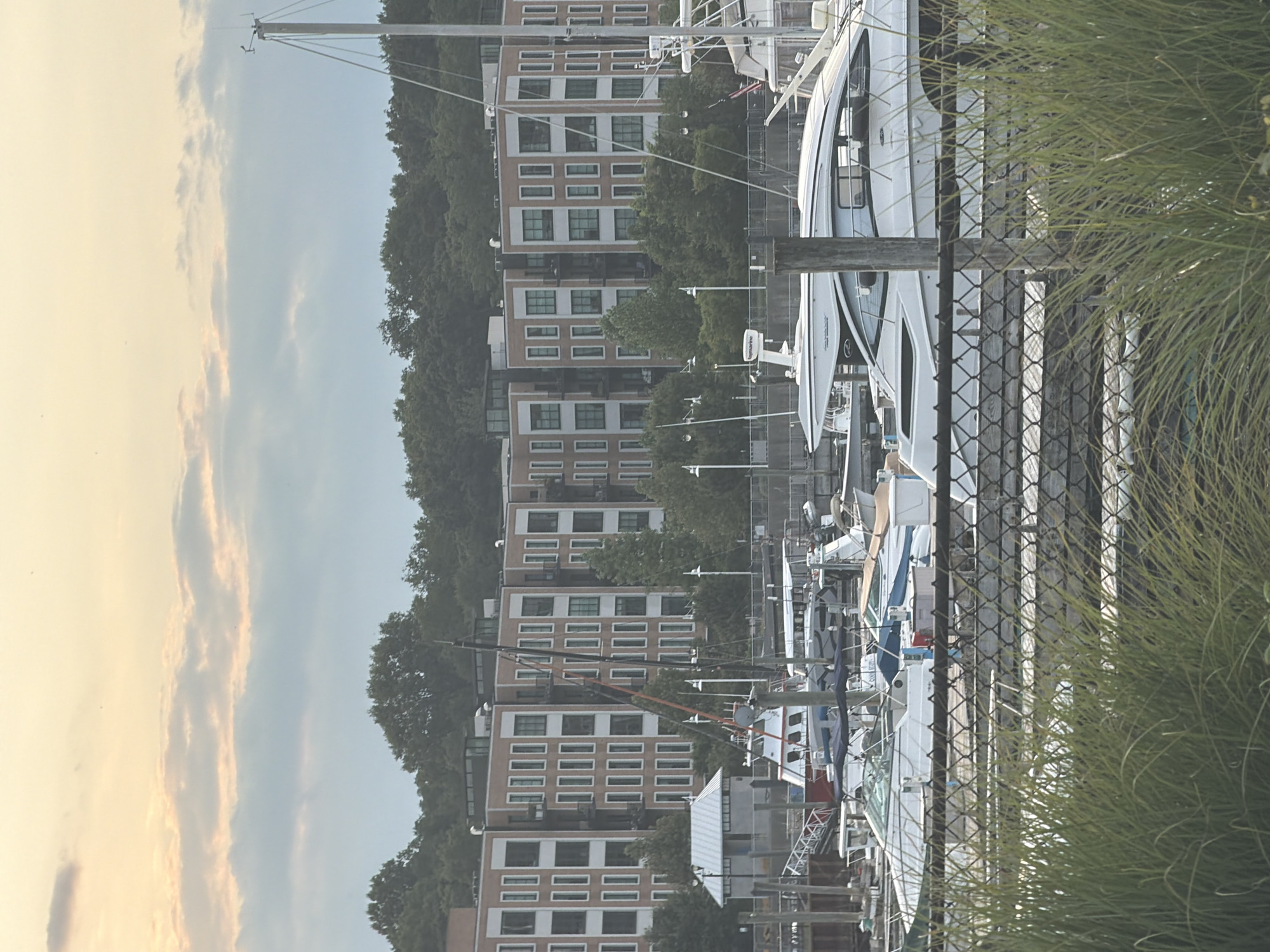 Glen Cove marina boats and waterfront apartments, July evening