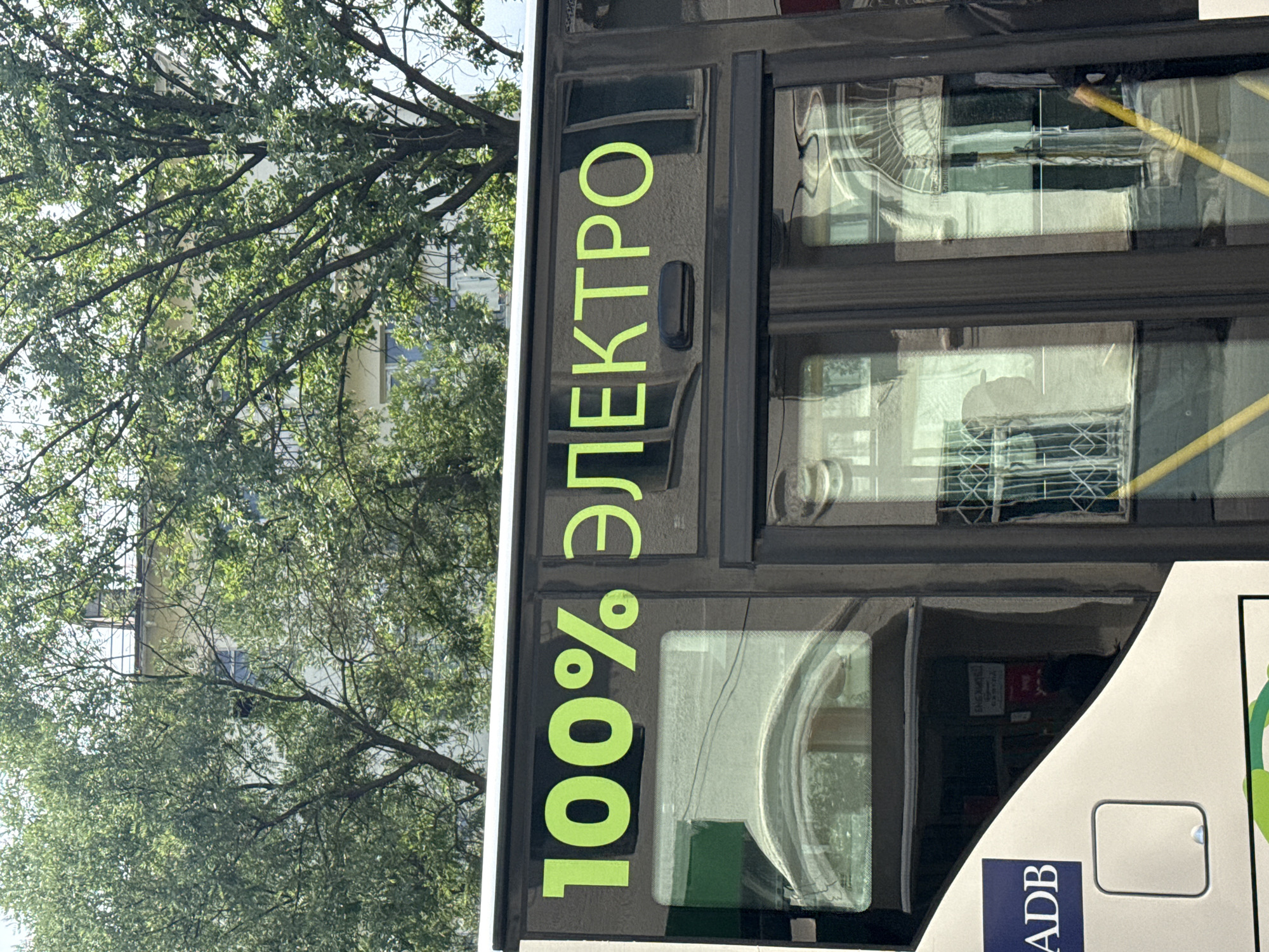 Electric buses and street life near a Central Asian market