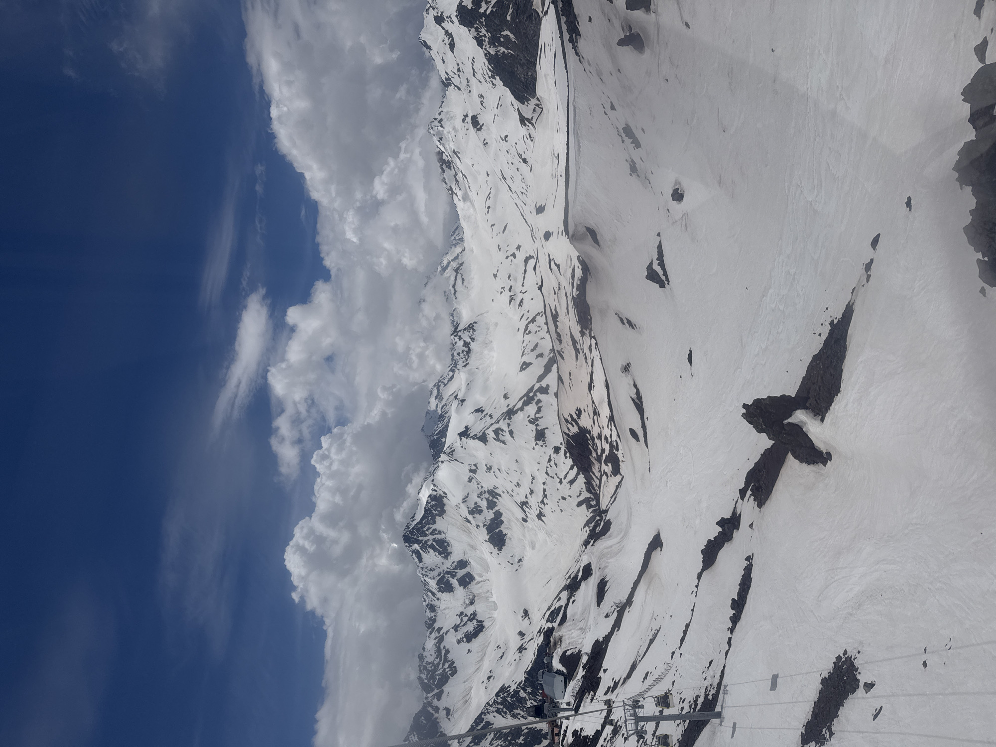 Snow-covered peaks and rocky ridges above Terskol, Russia