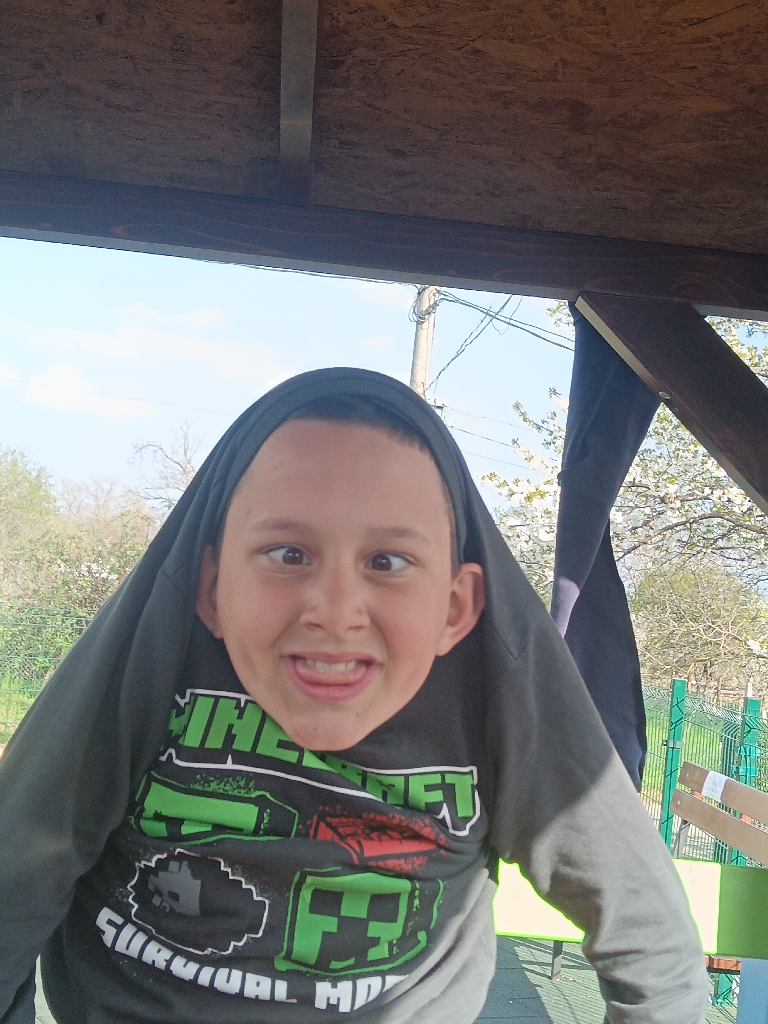 Boy plays at small town playground Sunday afternoon