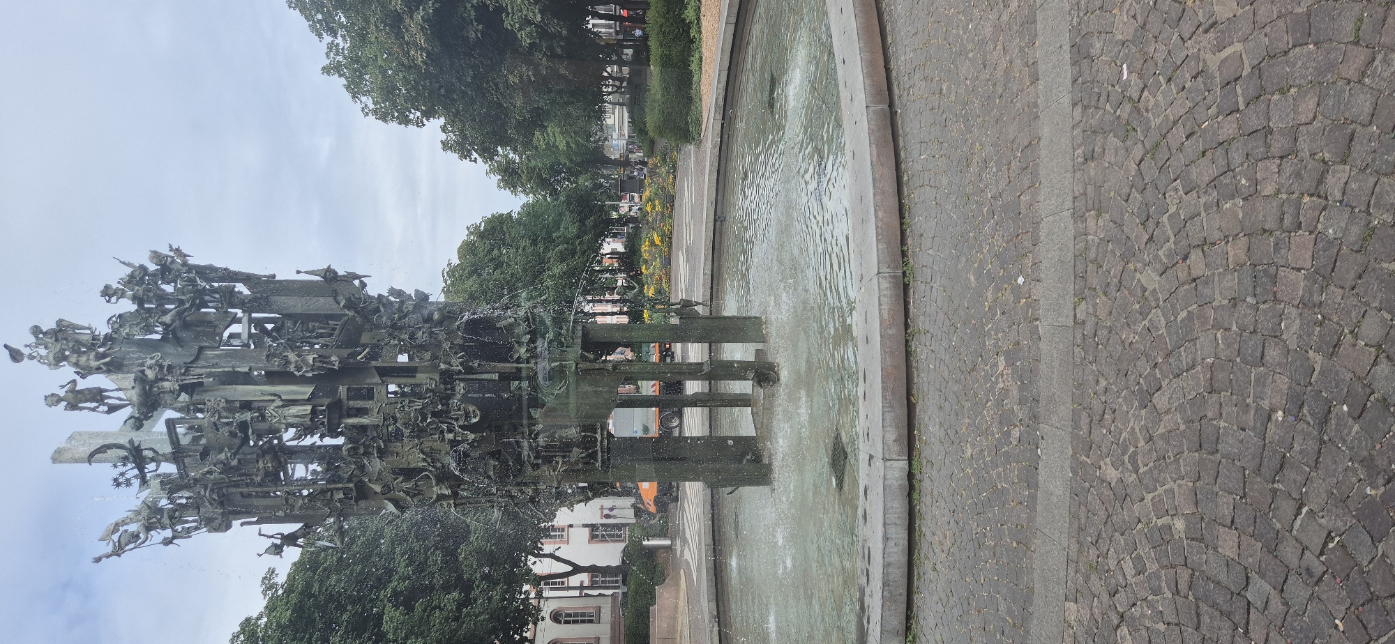 Intricate bronze fountain spraying in central Mainz