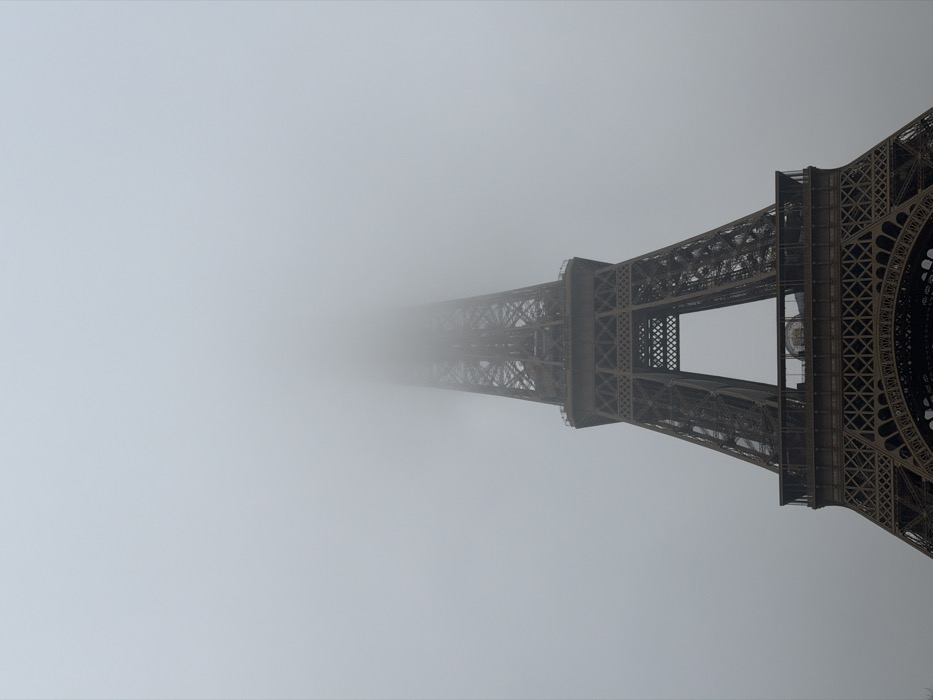 Folk dancers perform near Eiffel Tower during foggy Paris morning