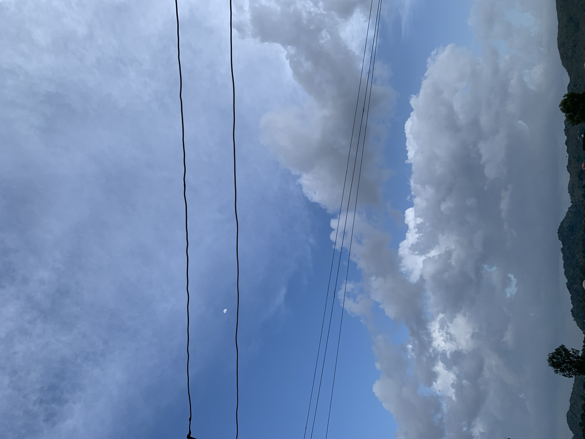 Shifting skies over Kuru Karama, from clear blue to storm clouds