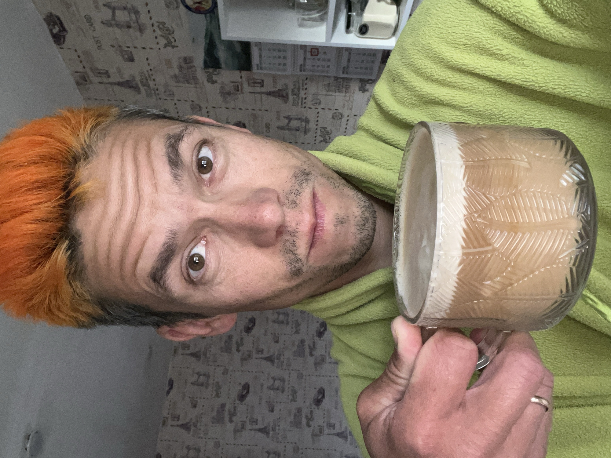 Orange-haired man takes coffee selfie in Chaikovsky home