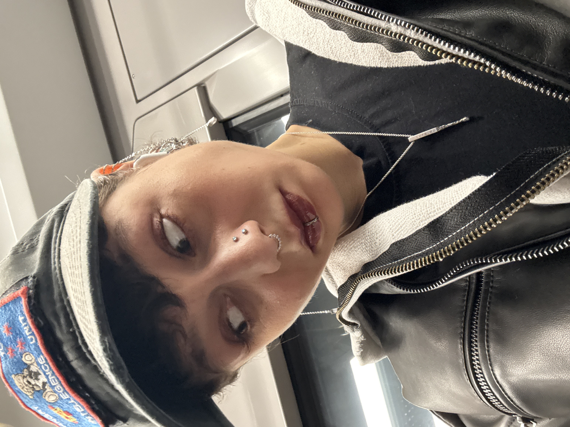 Person with facial piercings takes selfie in Moscow