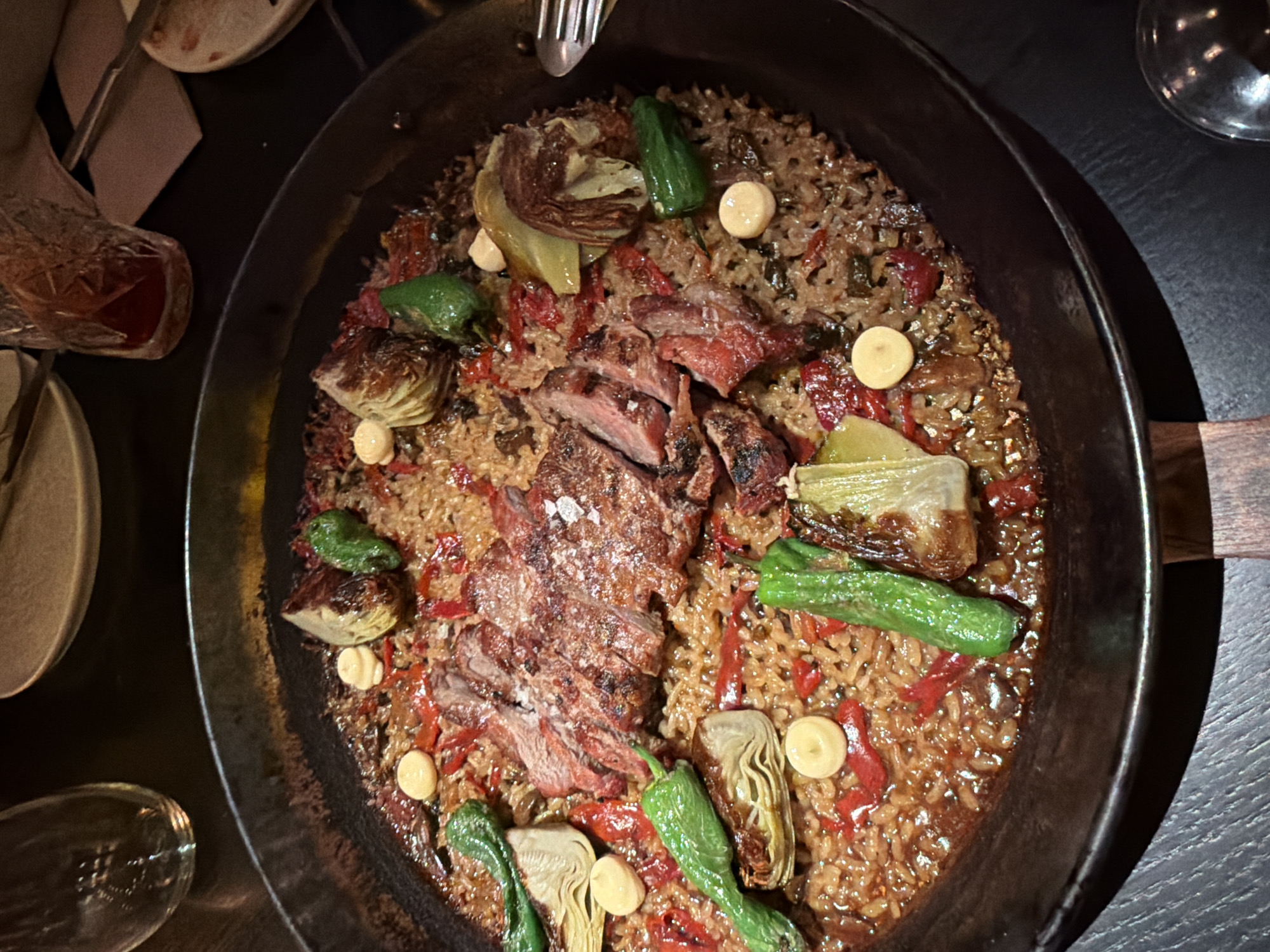 Diners photograph paella and sandwich at San Sebastián restaurant