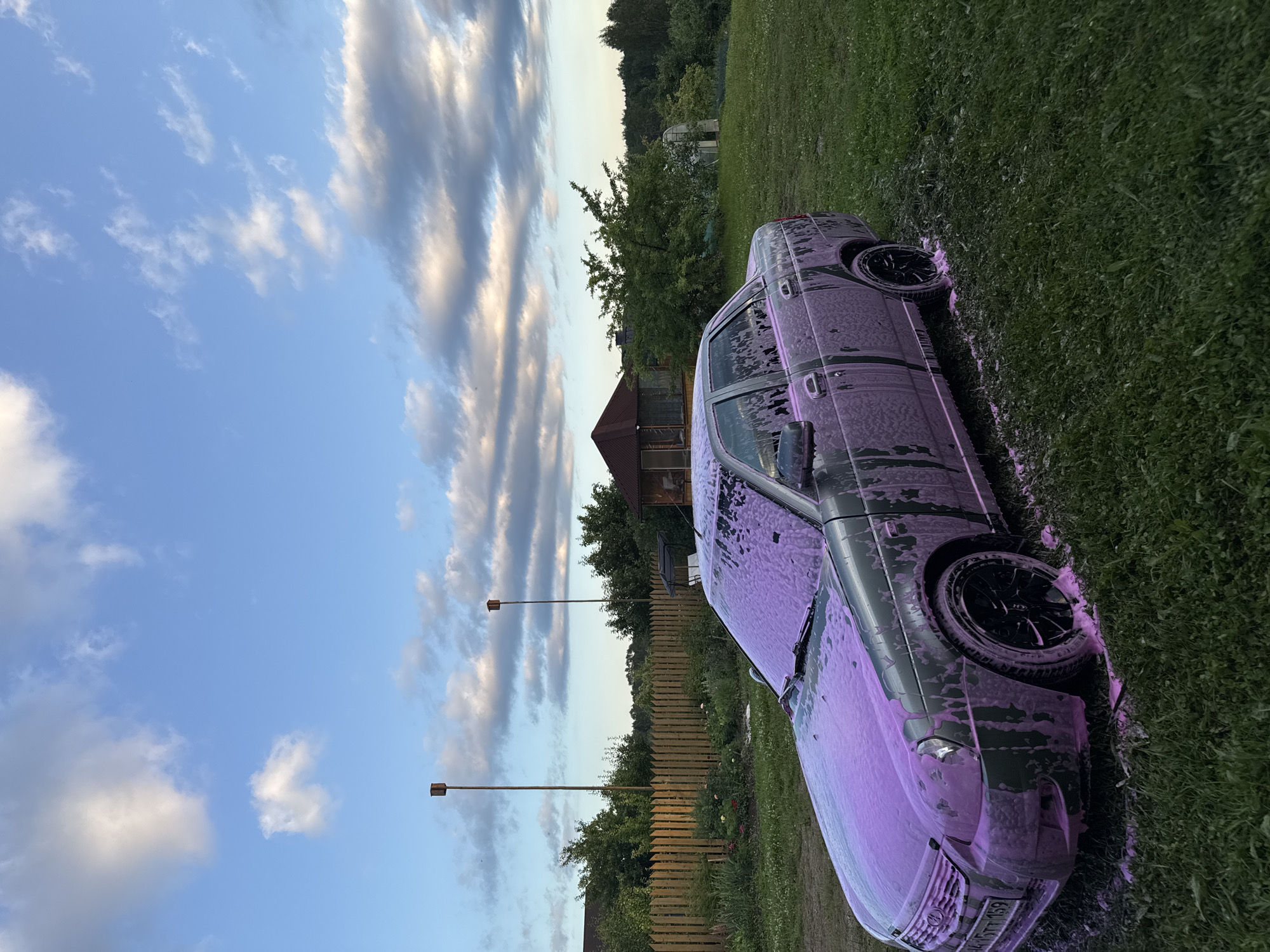 Backyard foam car wash in a rural Russian garden
