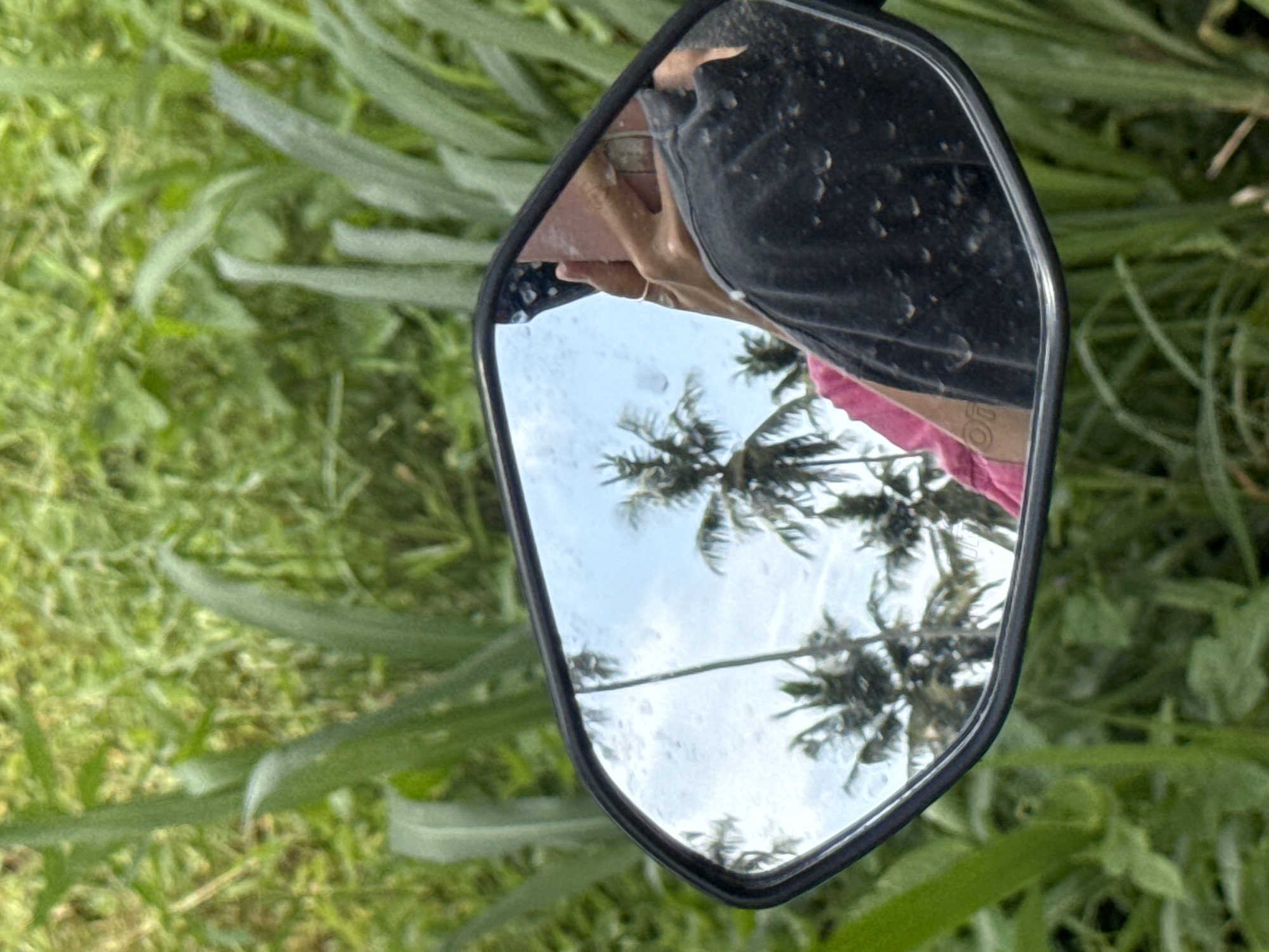 Motorbike rider captured in mirror reflection in Thiththagalla