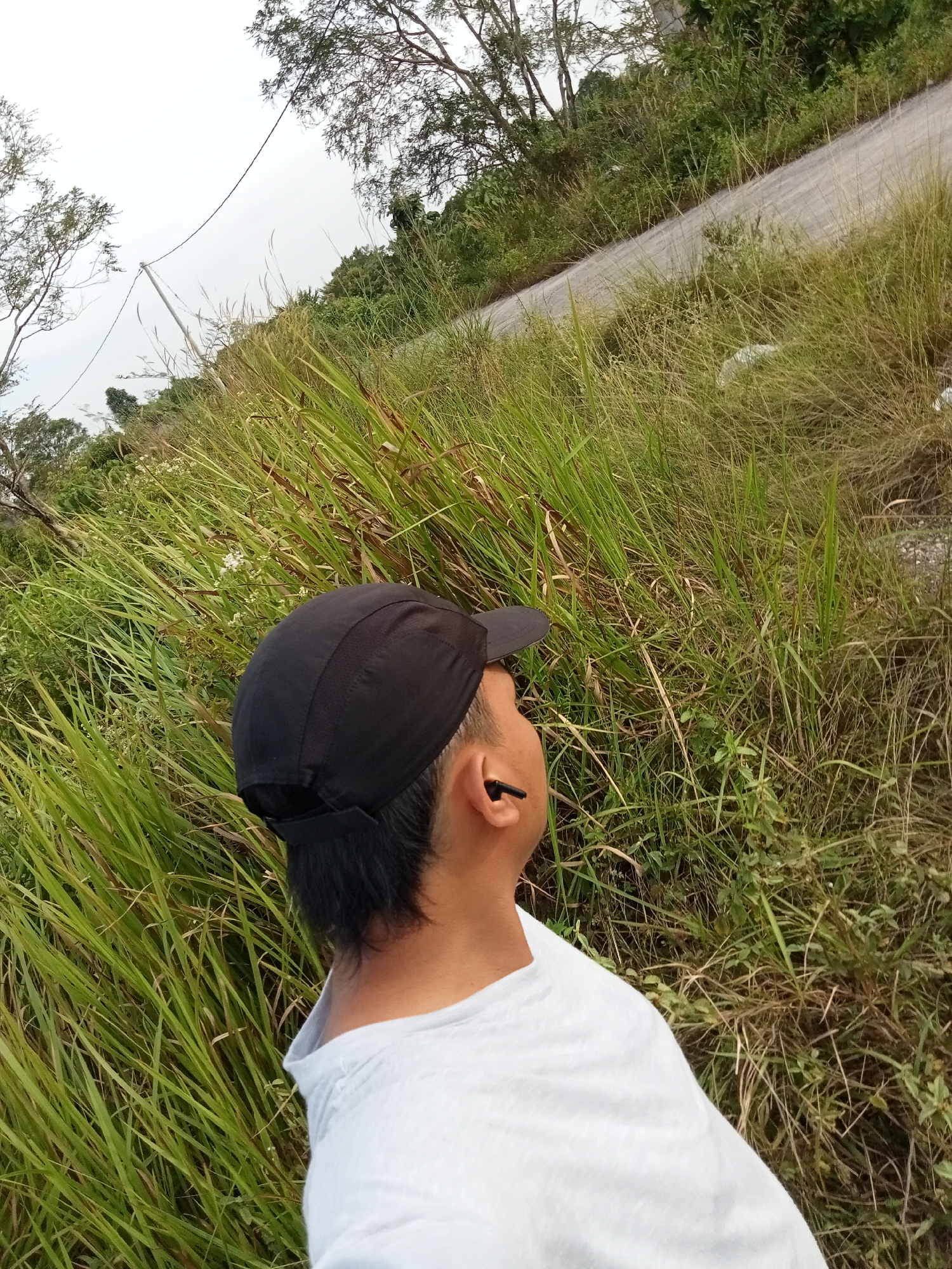 Morning by the water in rural Riau — fishing, selfies, and street cats