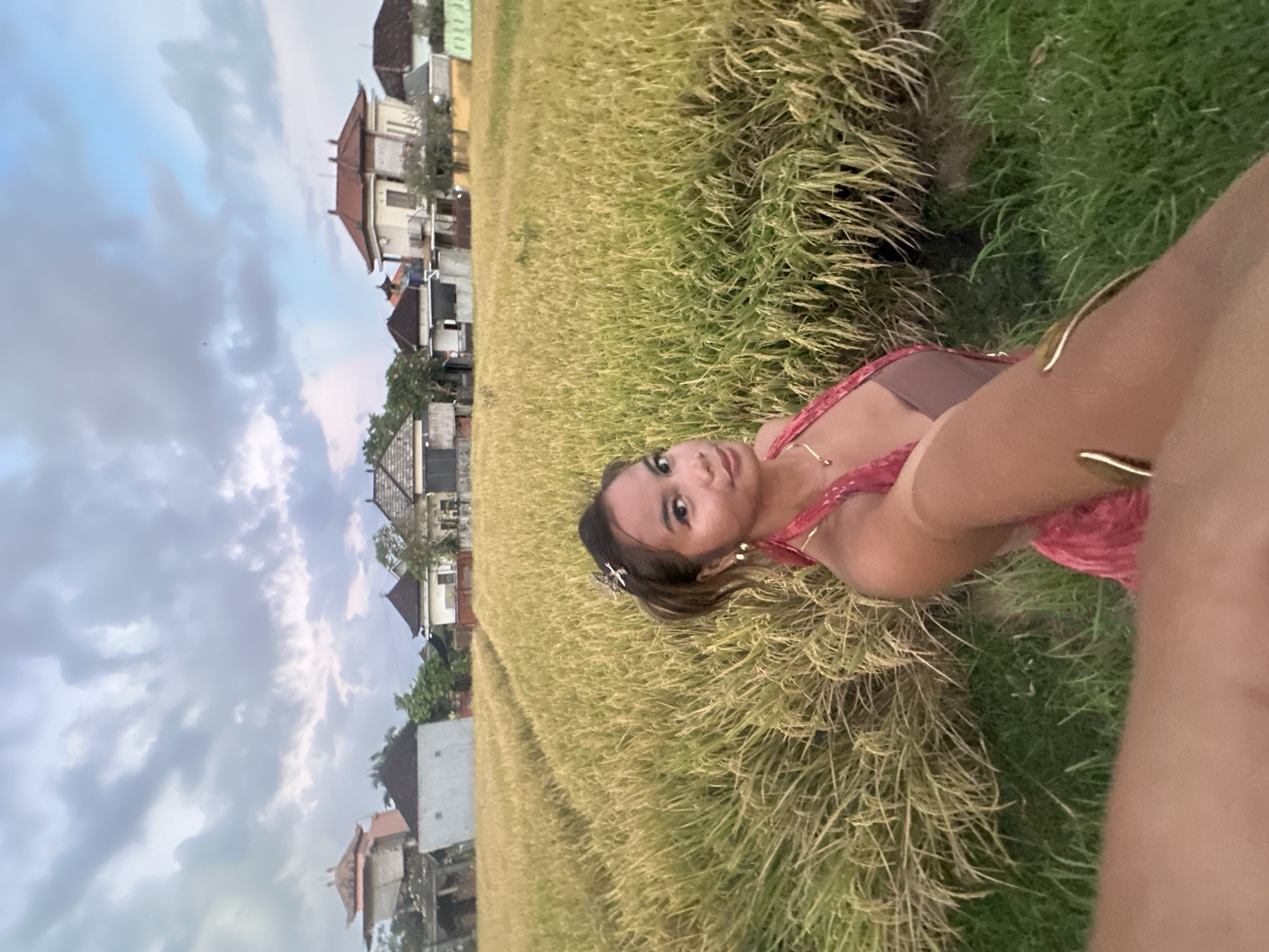 Woman films selfies in Indonesian rice fields as kites fly overhead