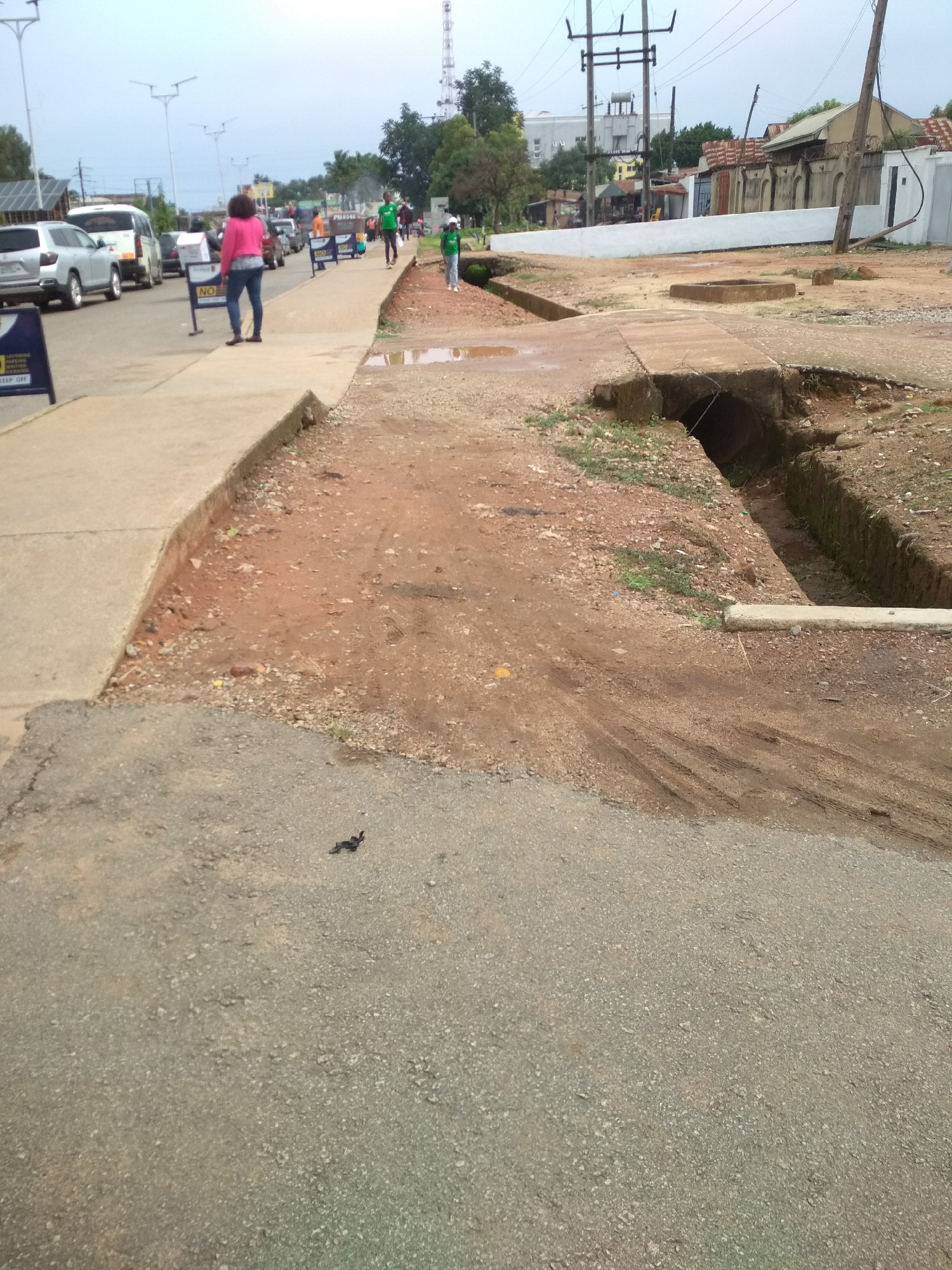 Daily life unfolds on Jos streets under cloudy skies
