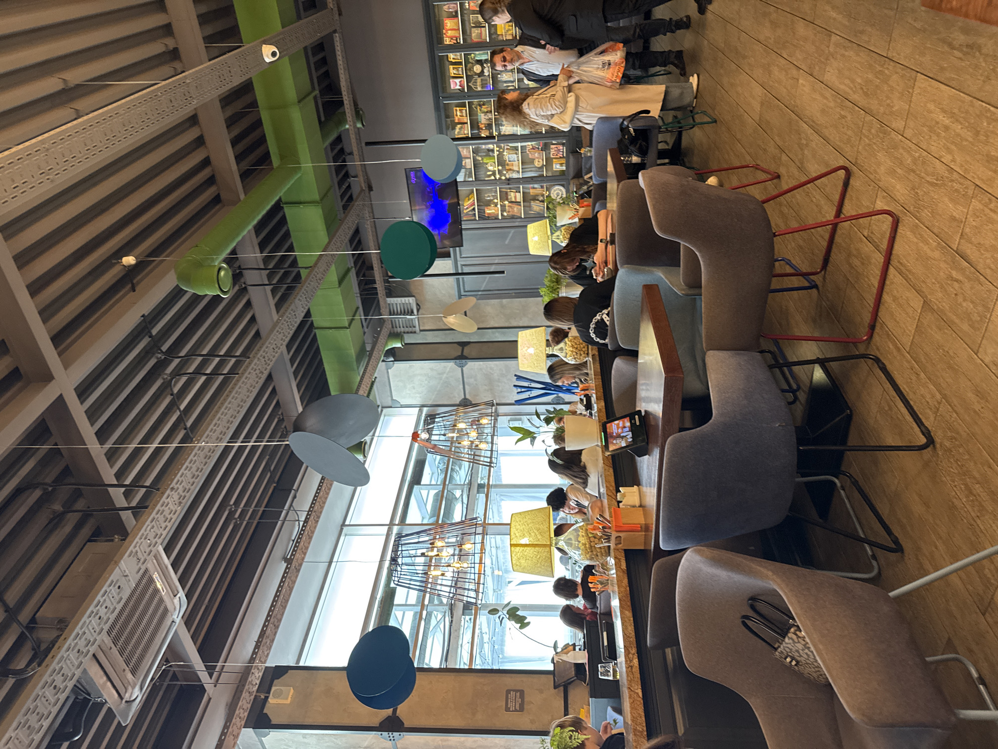 Afternoon diners gather at Saint Petersburg restaurant, woman reads Tokyo book