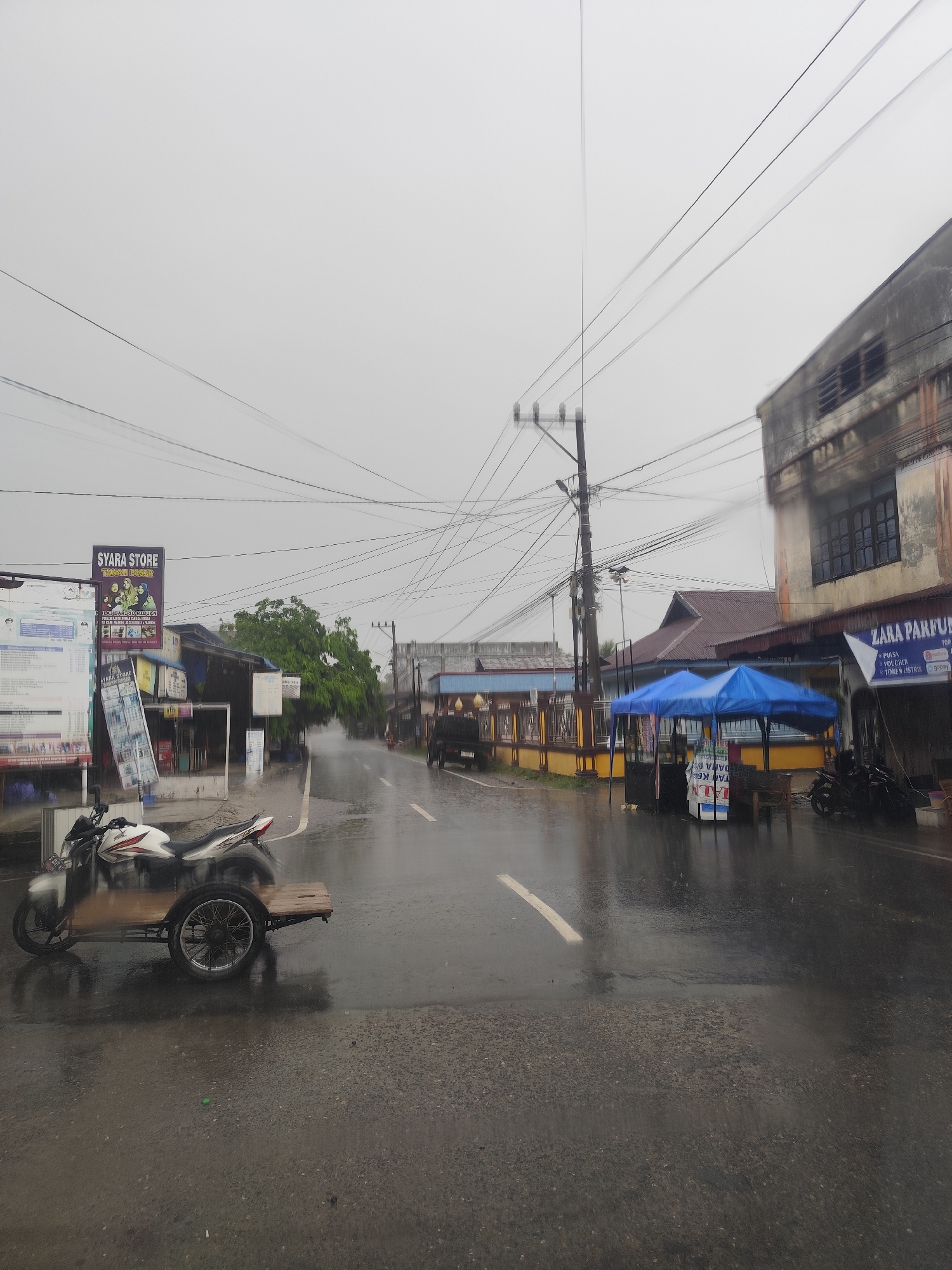 Morning rainfall documented on quiet Indonesian street
