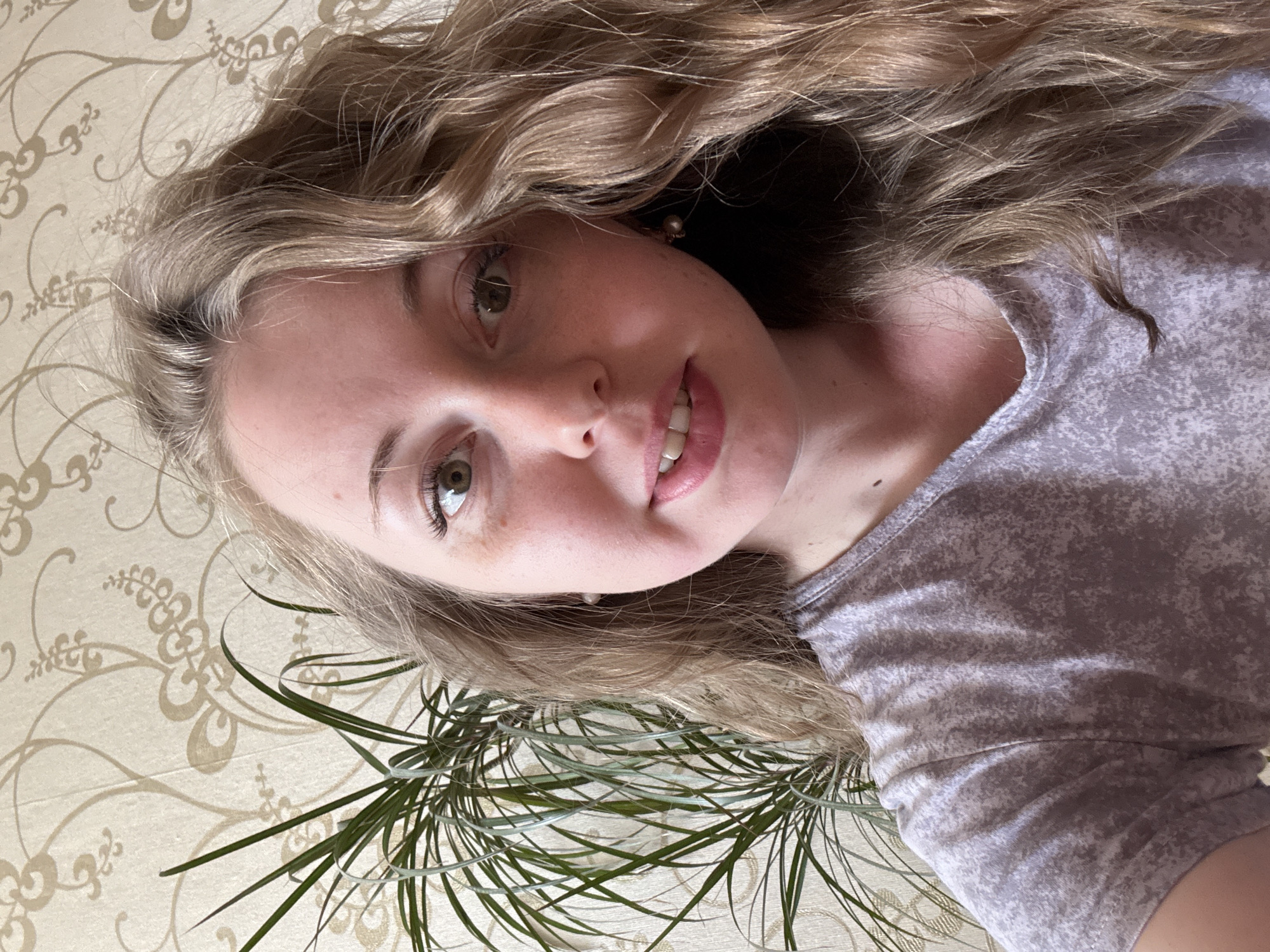 Woman documents morning selfie session with props and mirrors