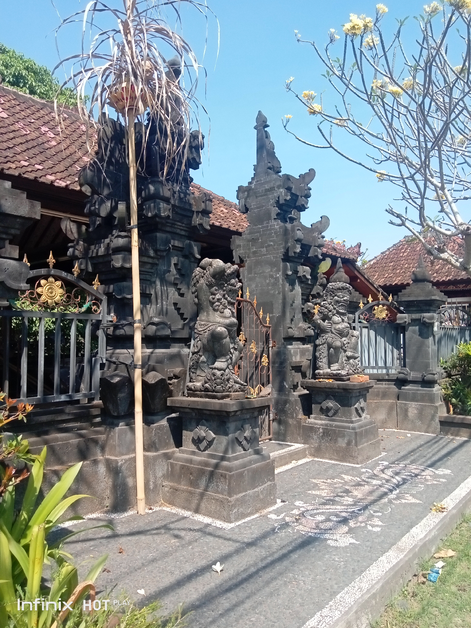 Balinese temple entrance with stone guardians and ornate carvings