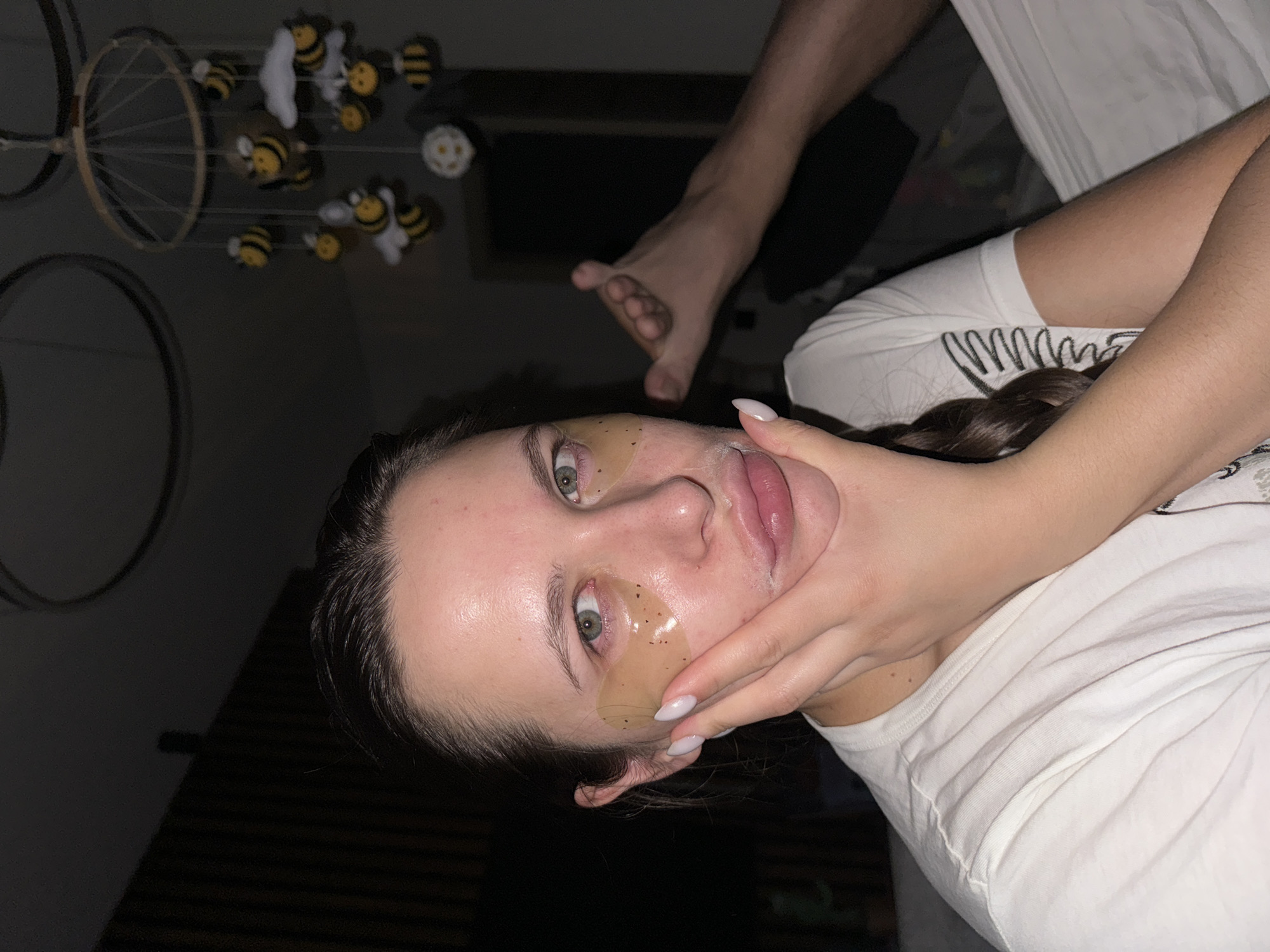 Woman applies eye patches indoors in Akulovo, Russia