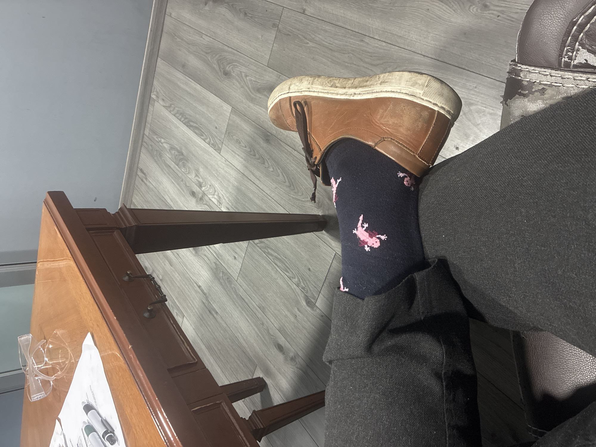 Person with flamingo socks sits by desk in Mexico