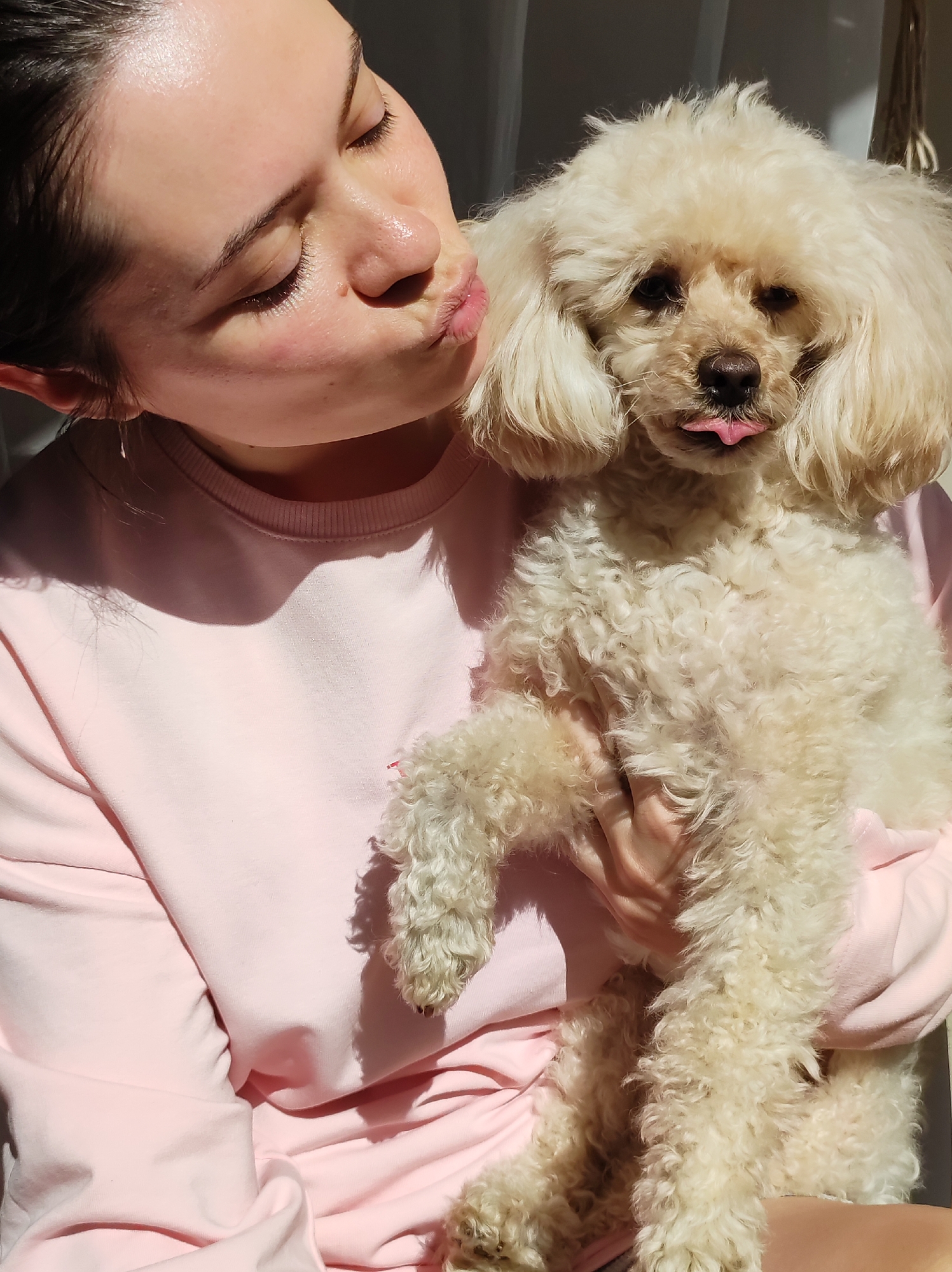 Woman photographs herself with poodle in Chaikovsky home