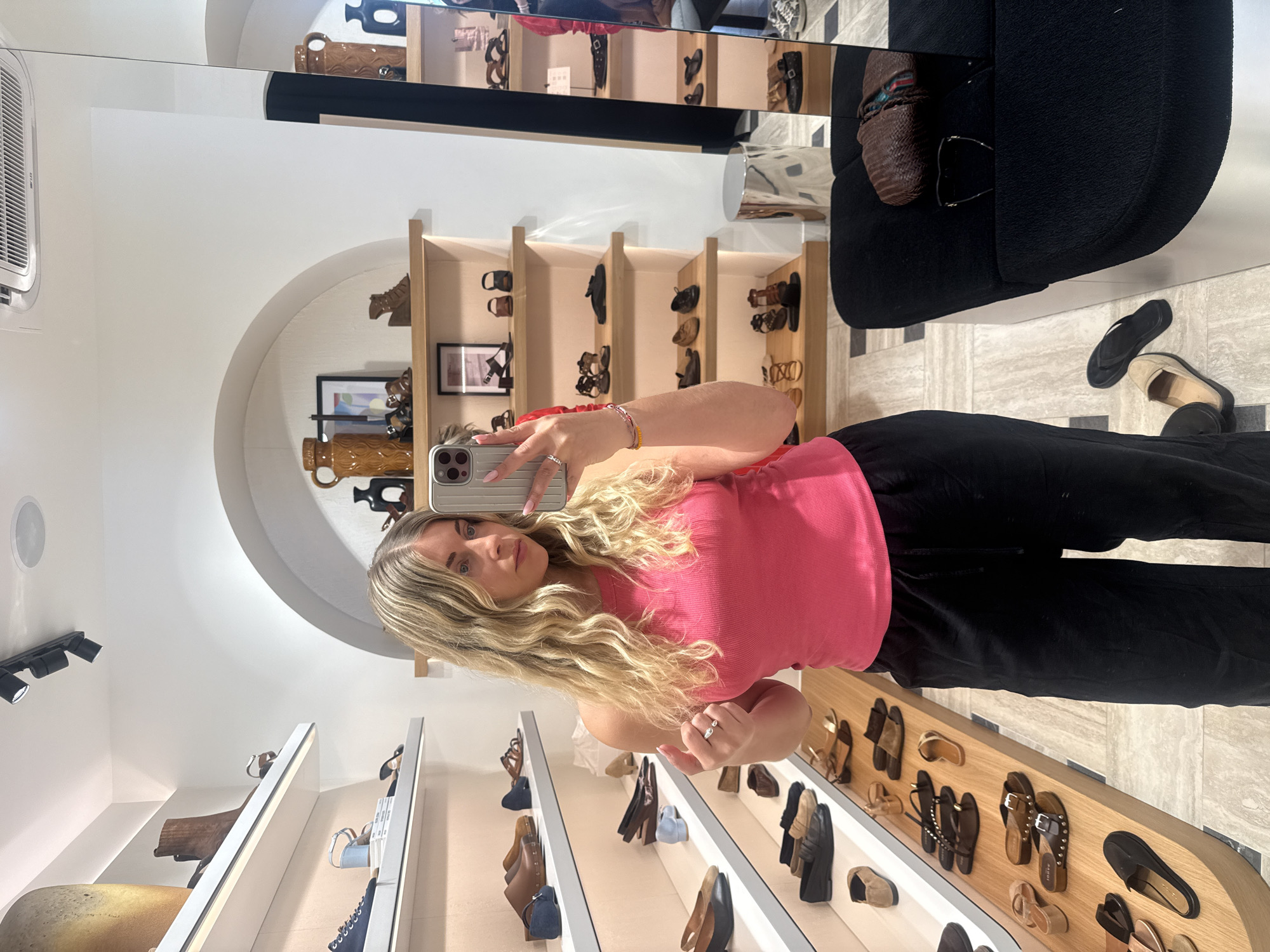 Woman takes selfie in Paris shoe store