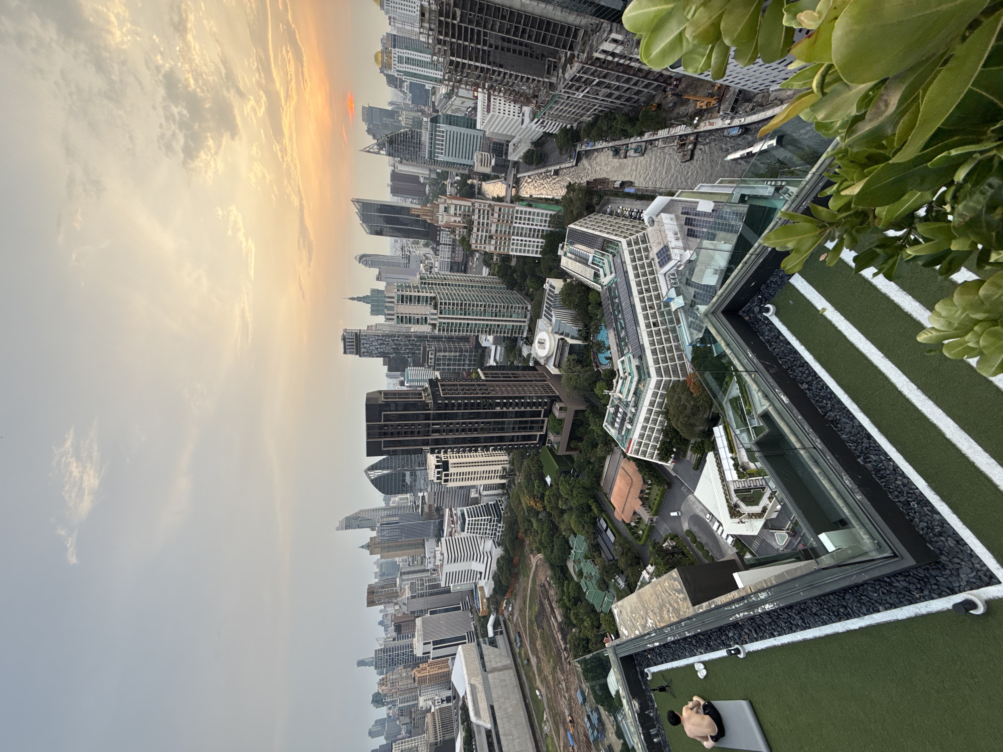 Bangkok rooftop yoga session captured amid dusk cityscape views