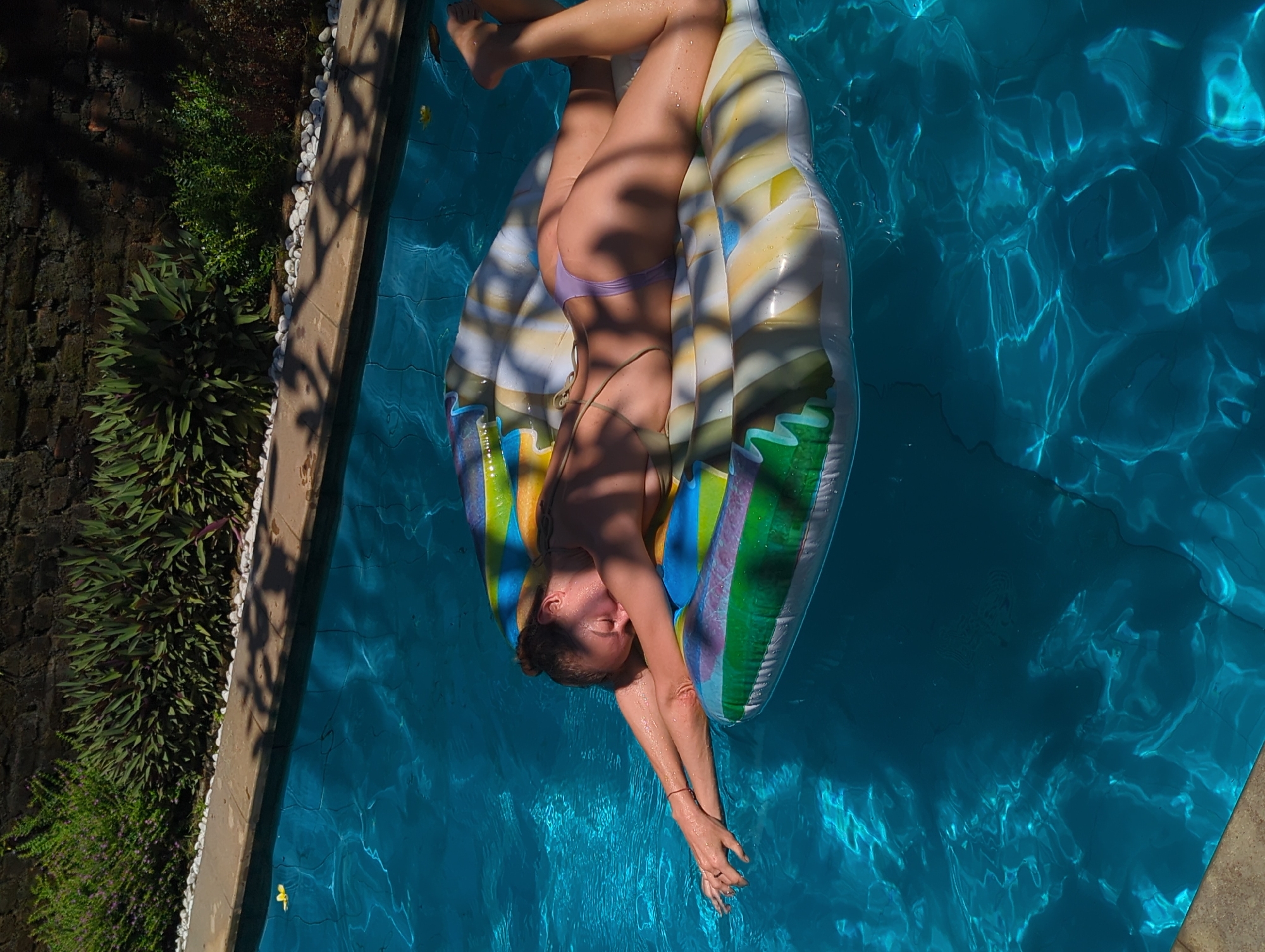 Woman relaxes on pool raft in North Kuta