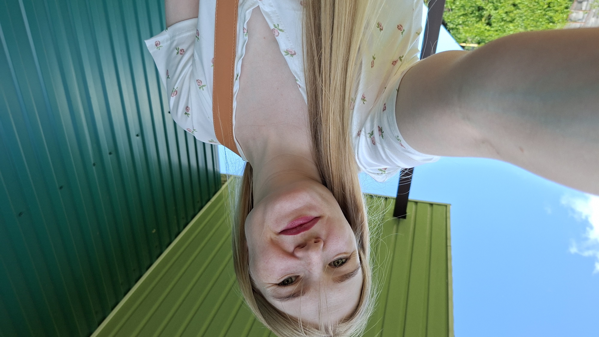 Woman takes selfies with child, pinwheel in Russian village