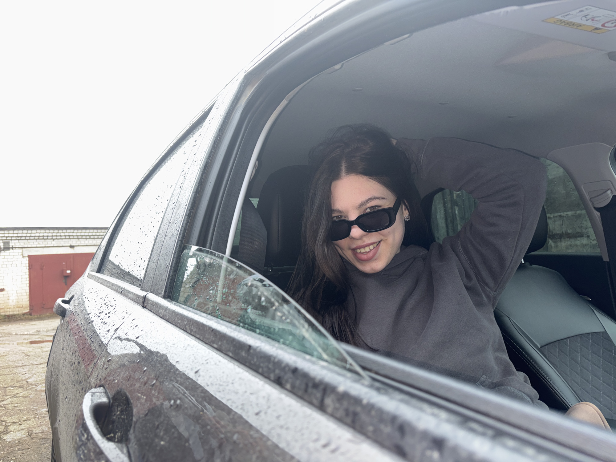 Woman spotted in car during rainy morning in Perm