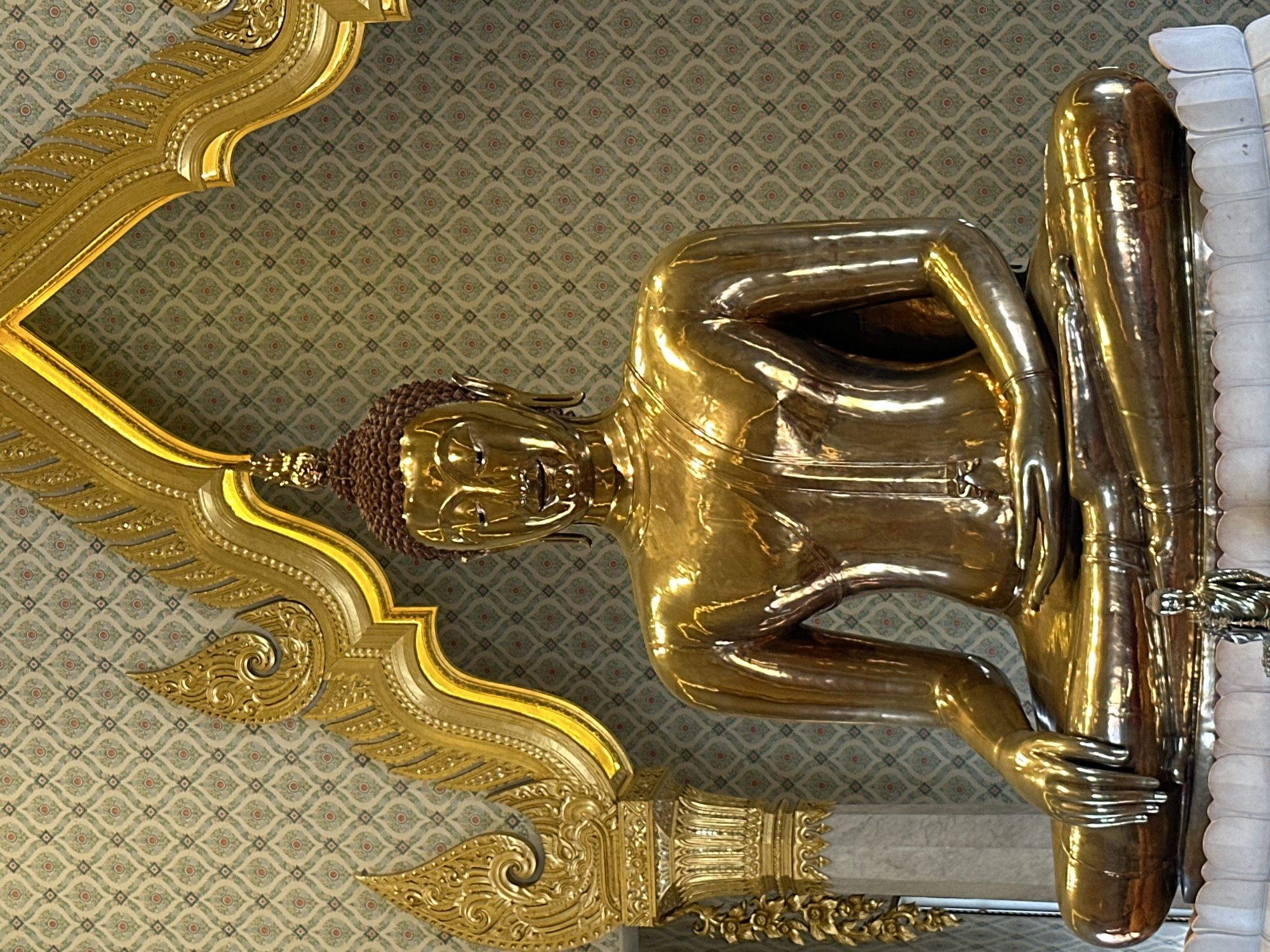 Tourist documents golden Buddha statues at Bangkok temples