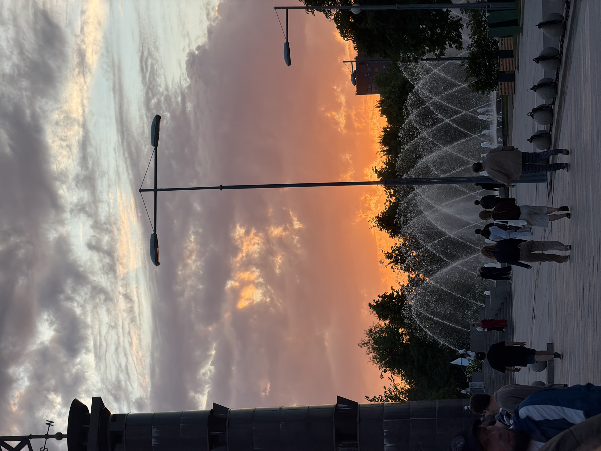 Woman captures playful sunset selfie in Saint Petersburg park