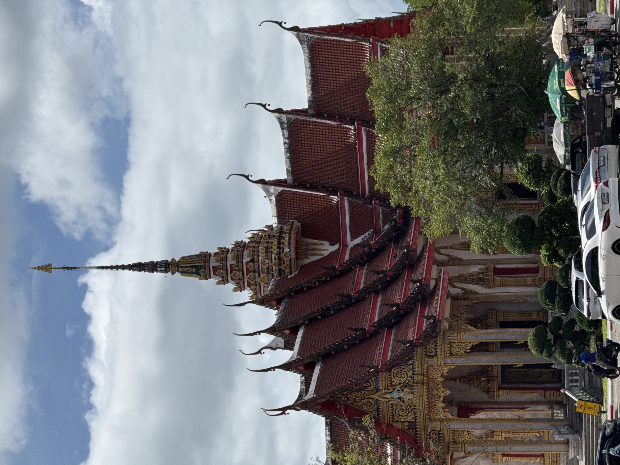 Exploring Wat Chalong temple grounds with a husky in tow