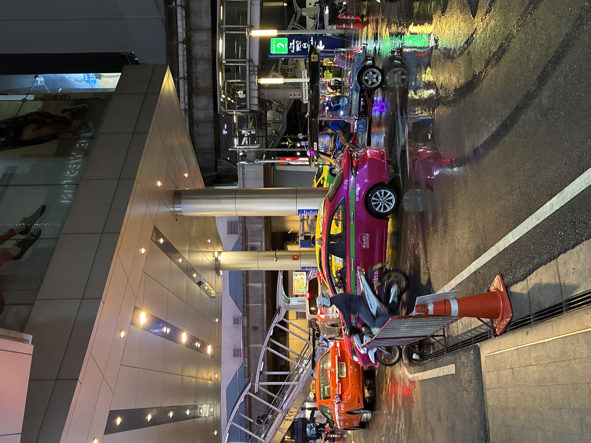 Rainy night traffic and street activity in central Bangkok
