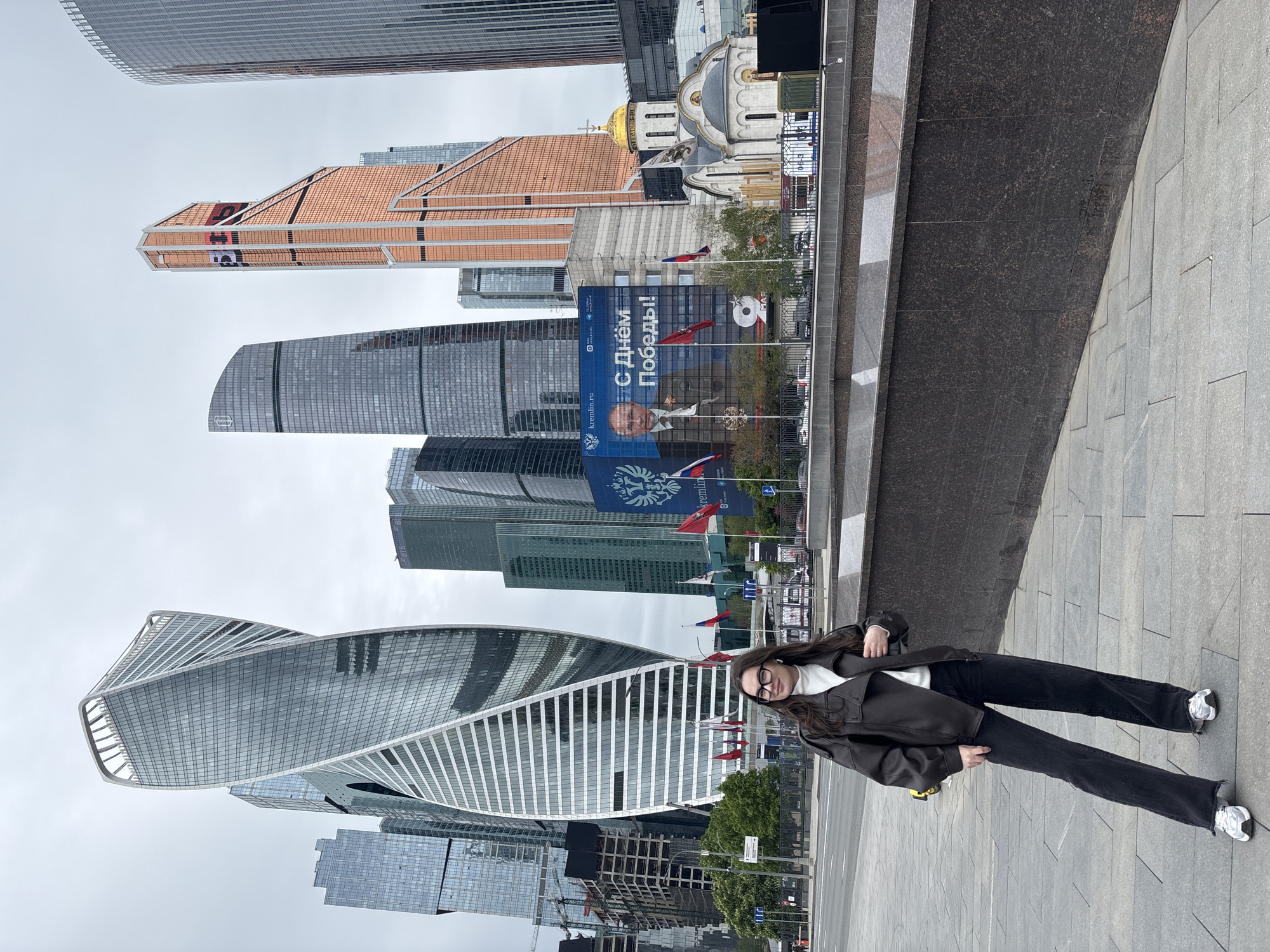 Woman photographs selfies at Moscow's business district skyline