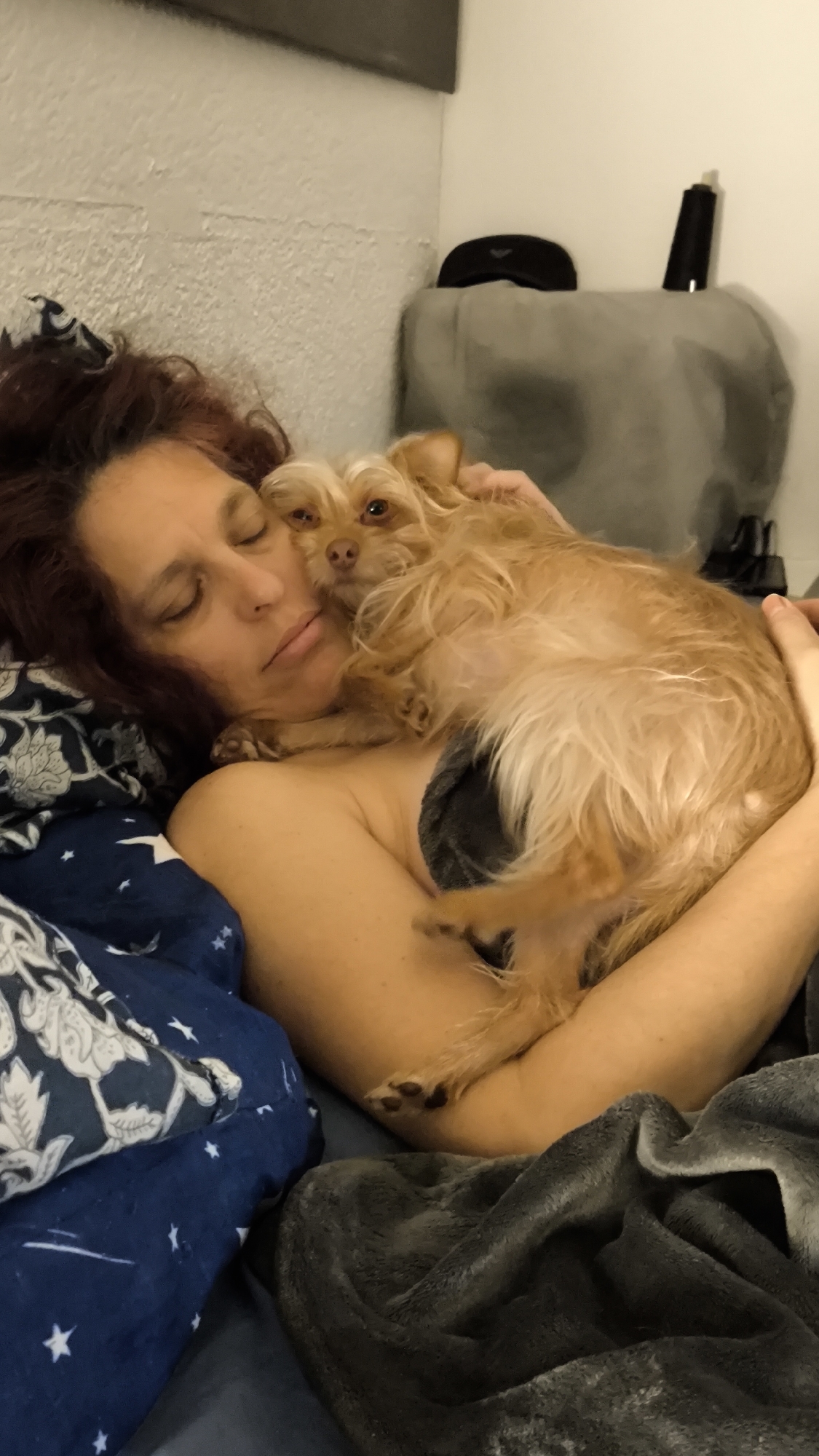 Woman and dog share quiet morning moments in bedroom