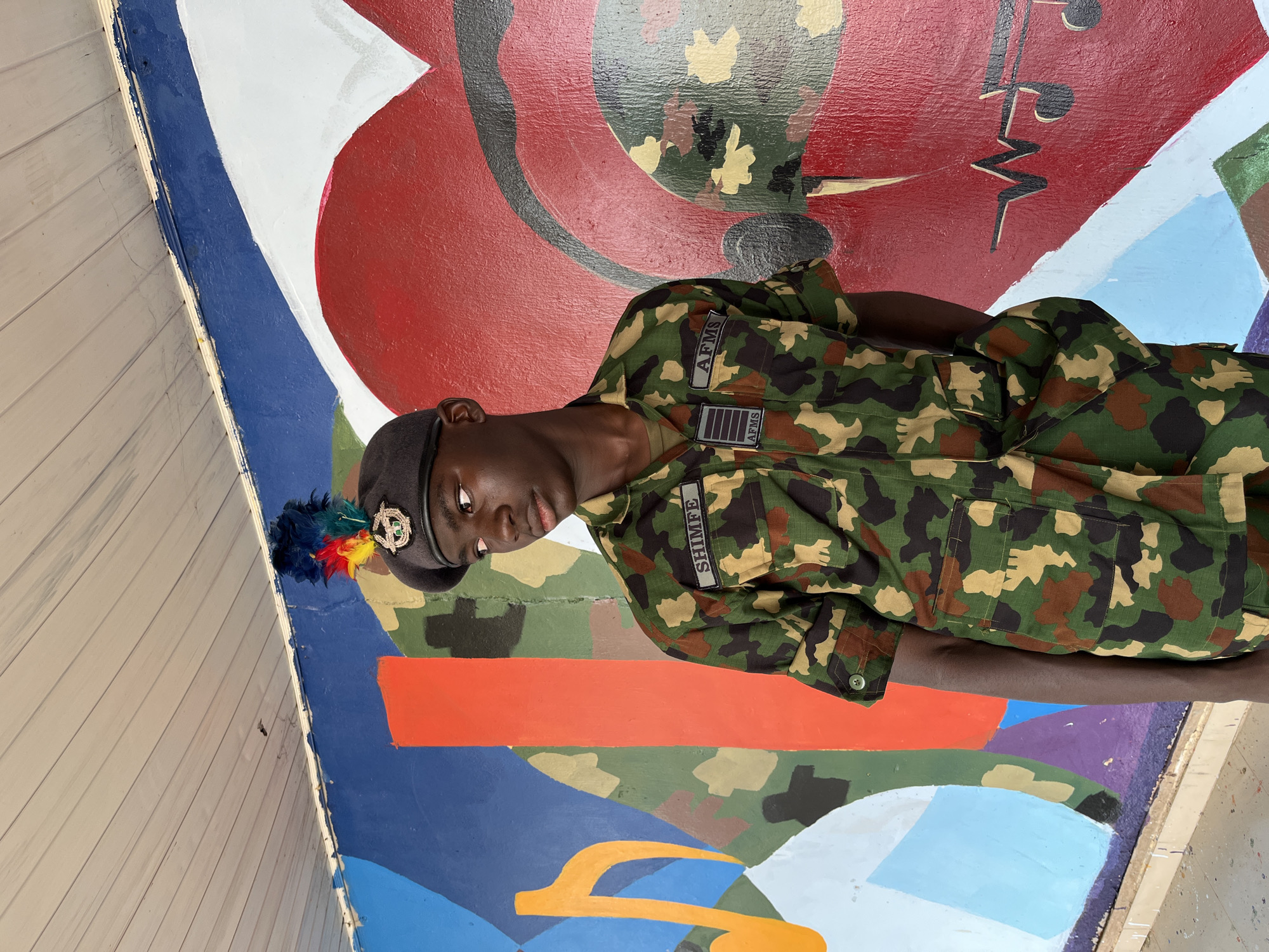 Group portraits in front of a vibrant mural in Bar Jirgi Summa