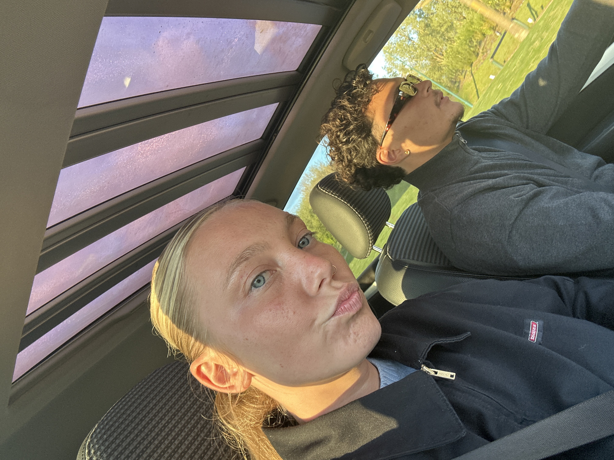 Two people captured in playful car moment in Serris