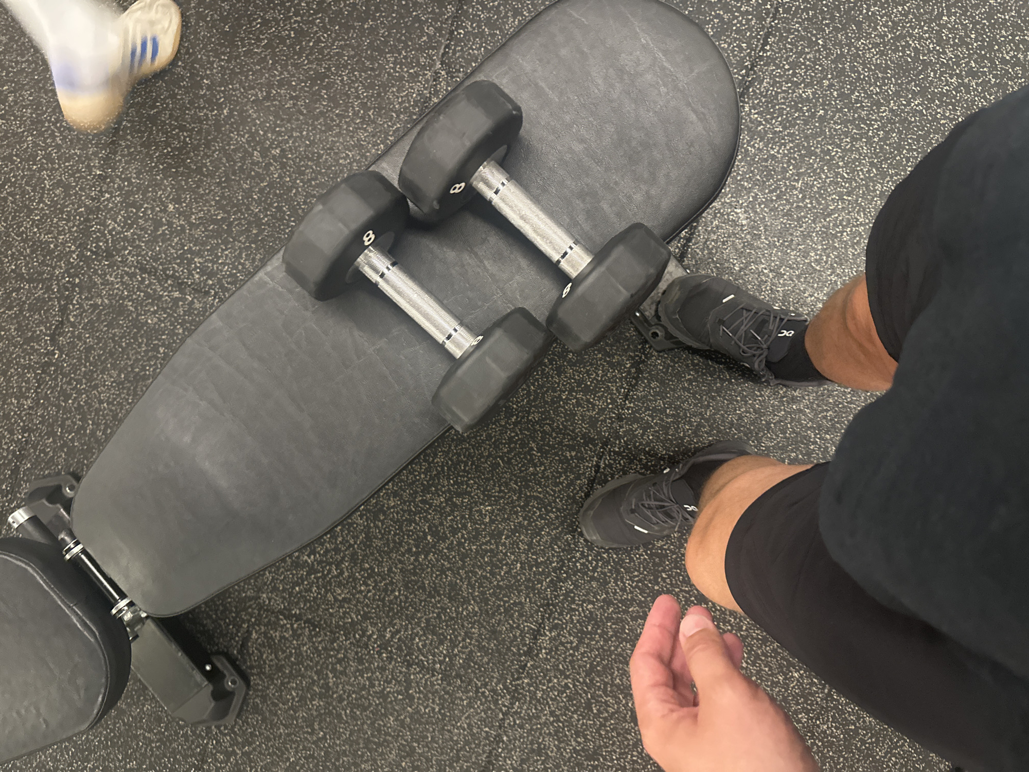 Gym scene captured with weight bench and dumbbells